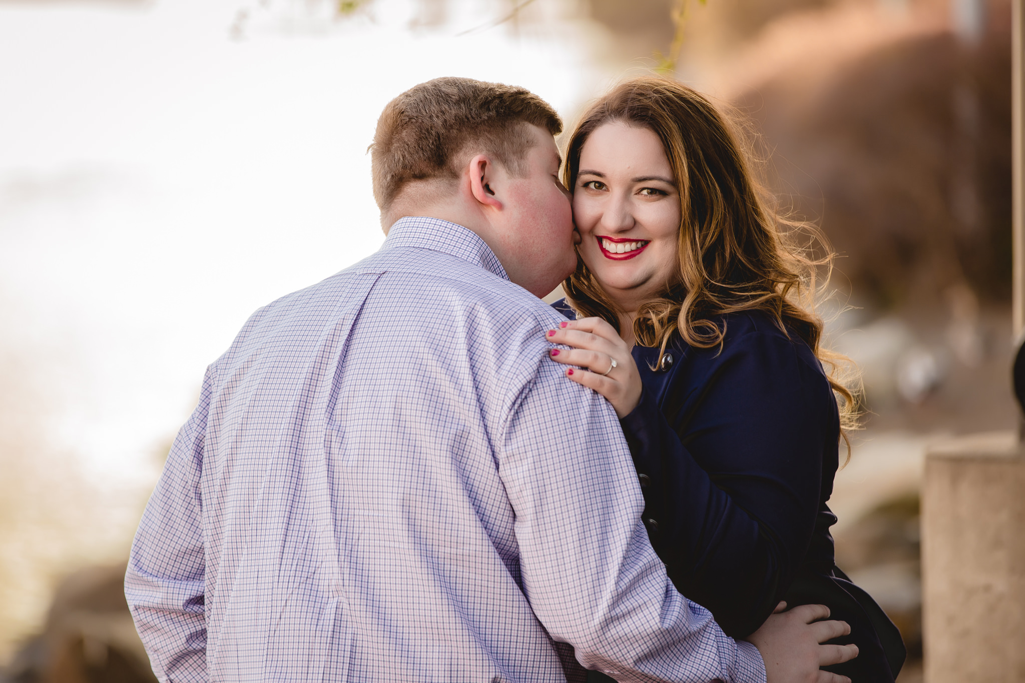 Groom-to-be kisses his fiance during a North Shore engagement session