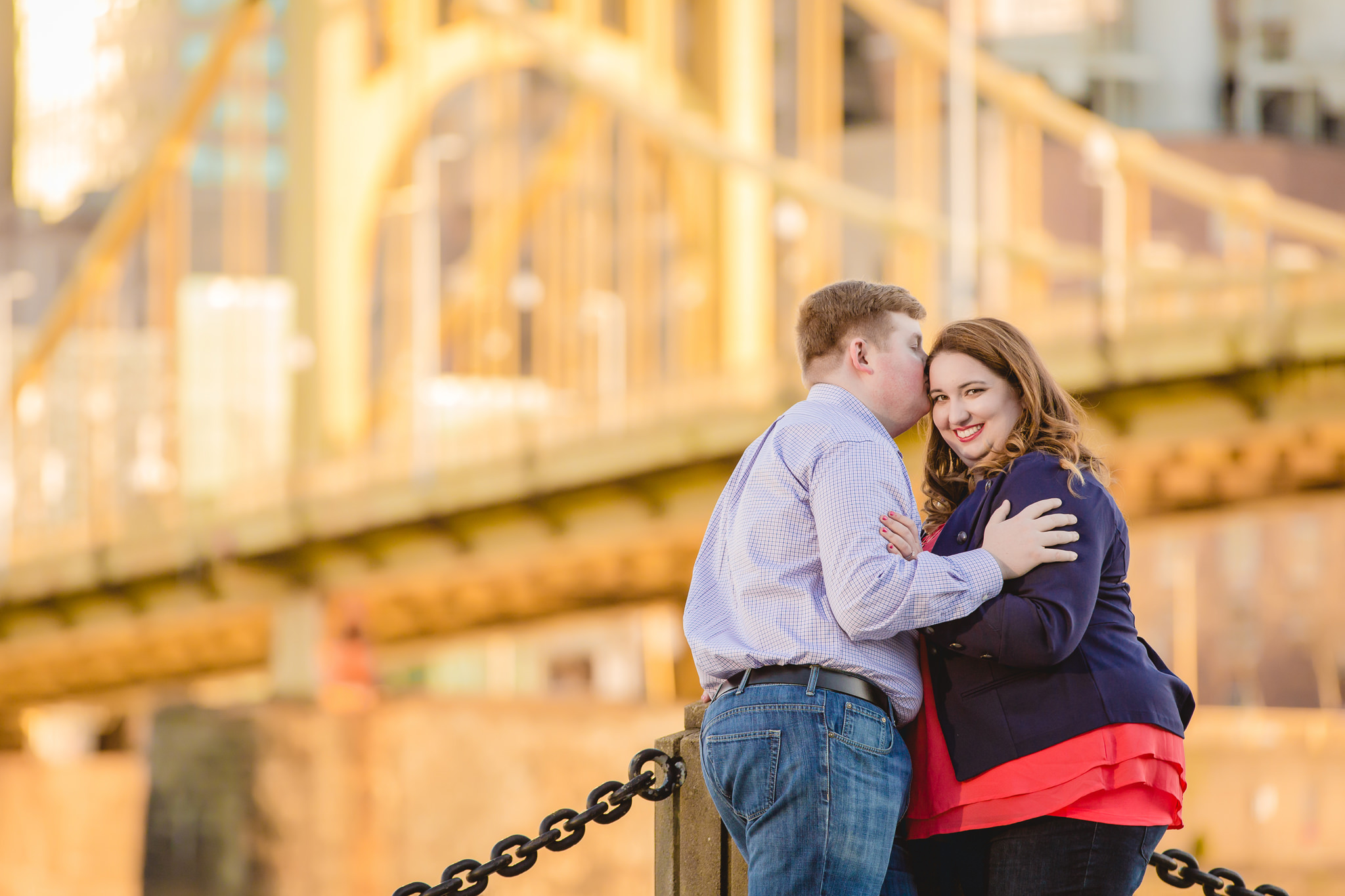 Bride-to-be gets a kiss from her fiance on Pittsburgh's North Shore riverwalk