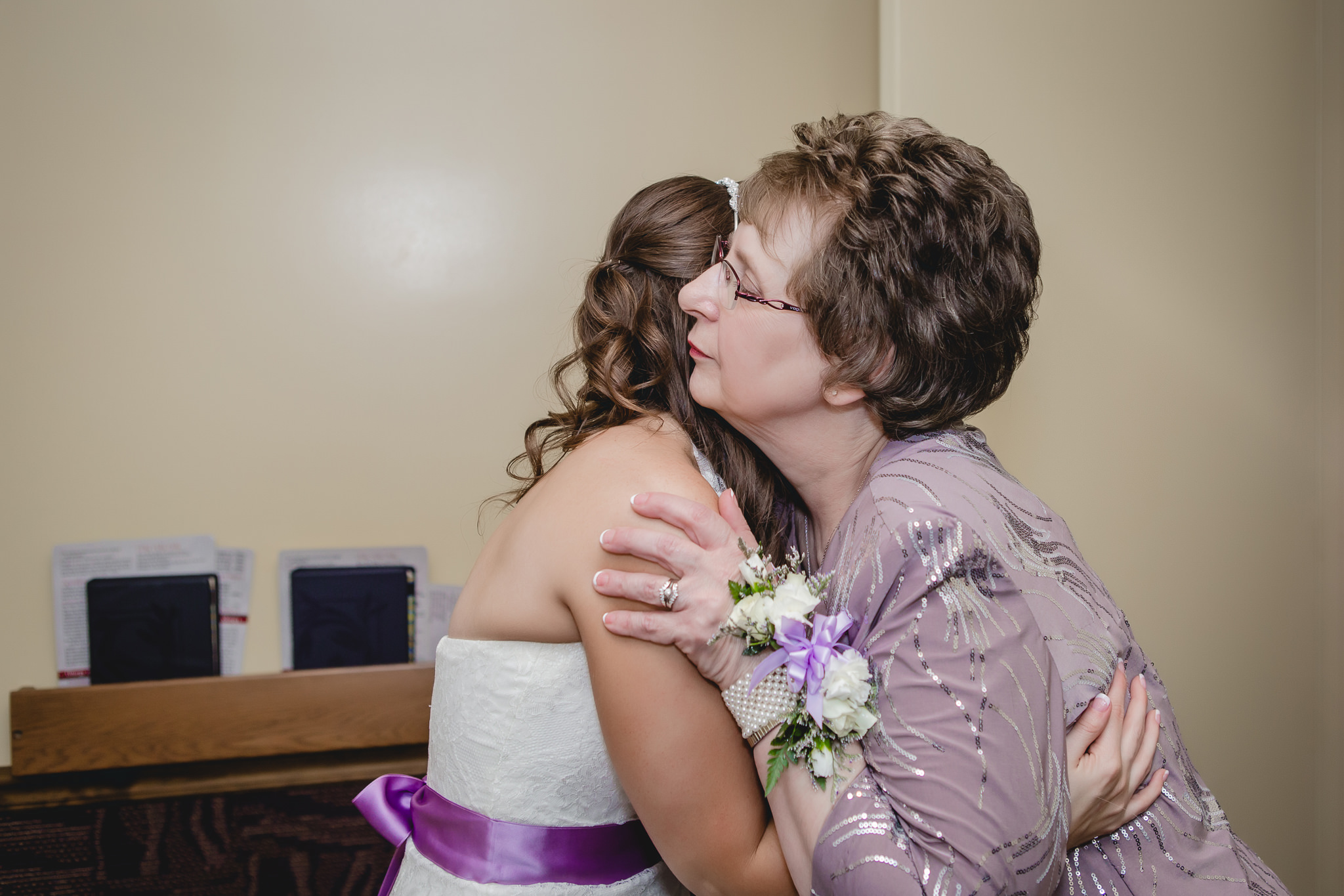 Mother of the bride hugs her daughter before St. Malachy wedding ceremony