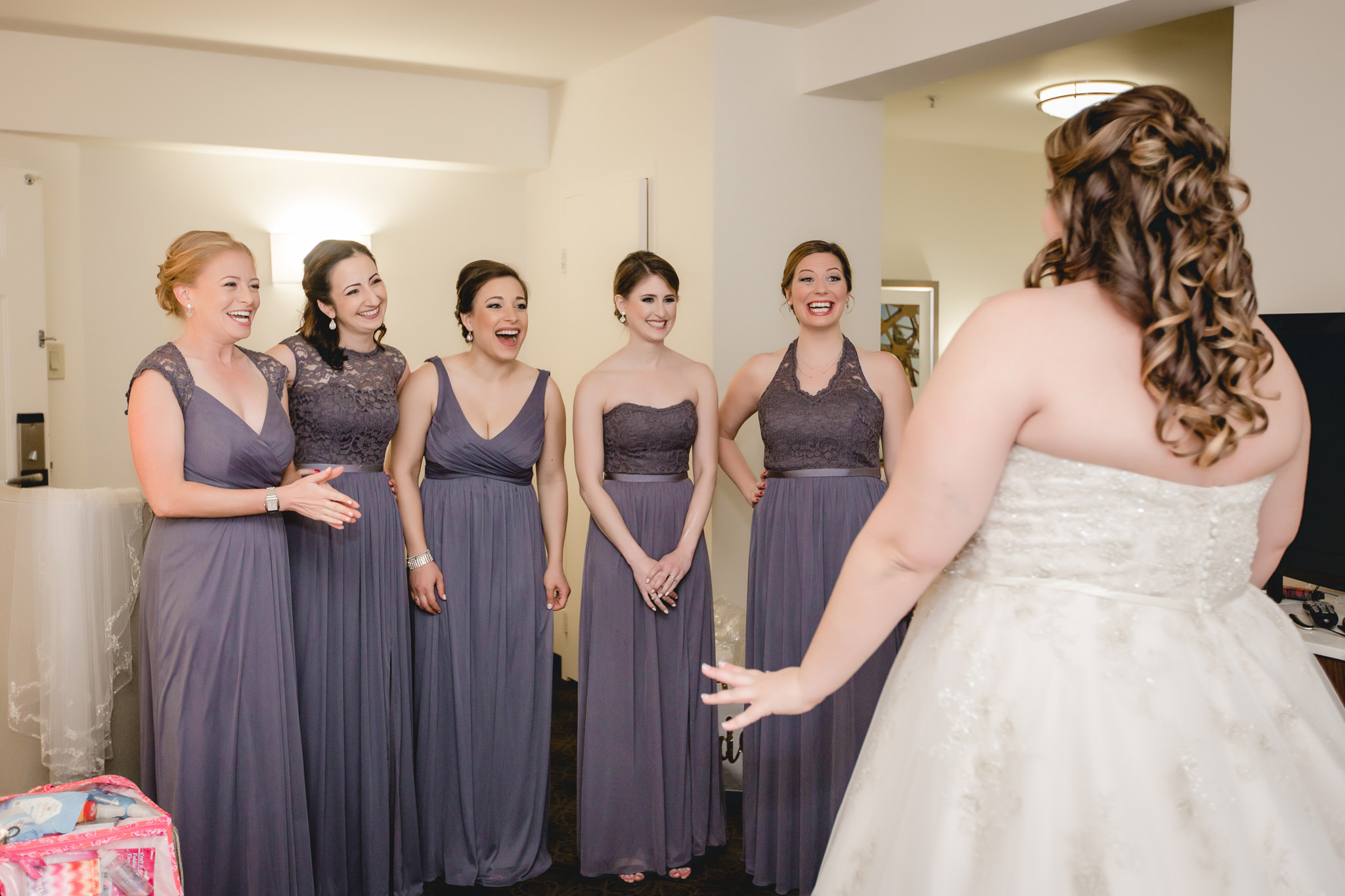 Bridesmaids react to bride in dress before her Pittsburgh wedding at Soldiers & Sailors
