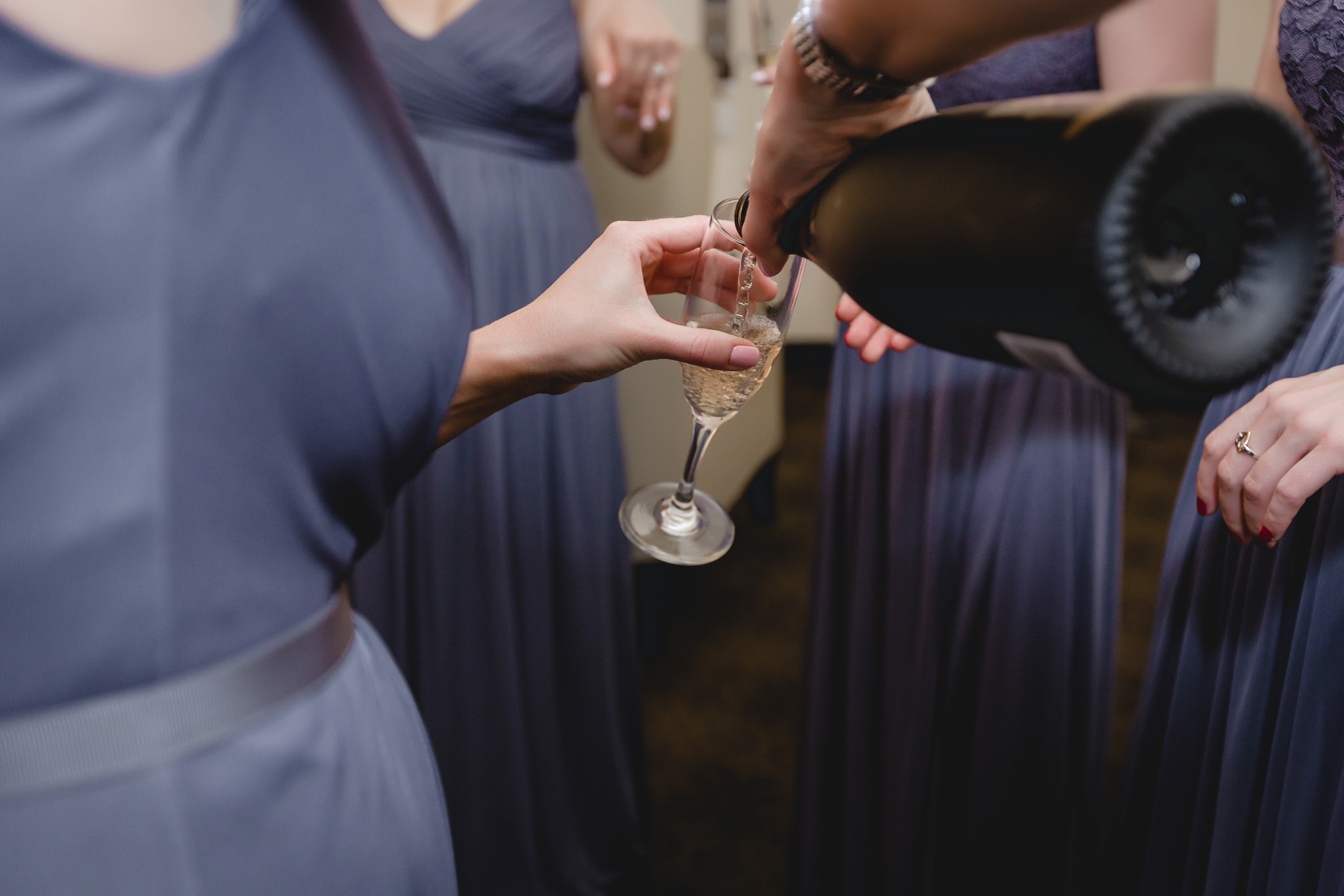Bridesmaids pouring champagne before a Pittsburgh wedding at Soldiers & Sailors