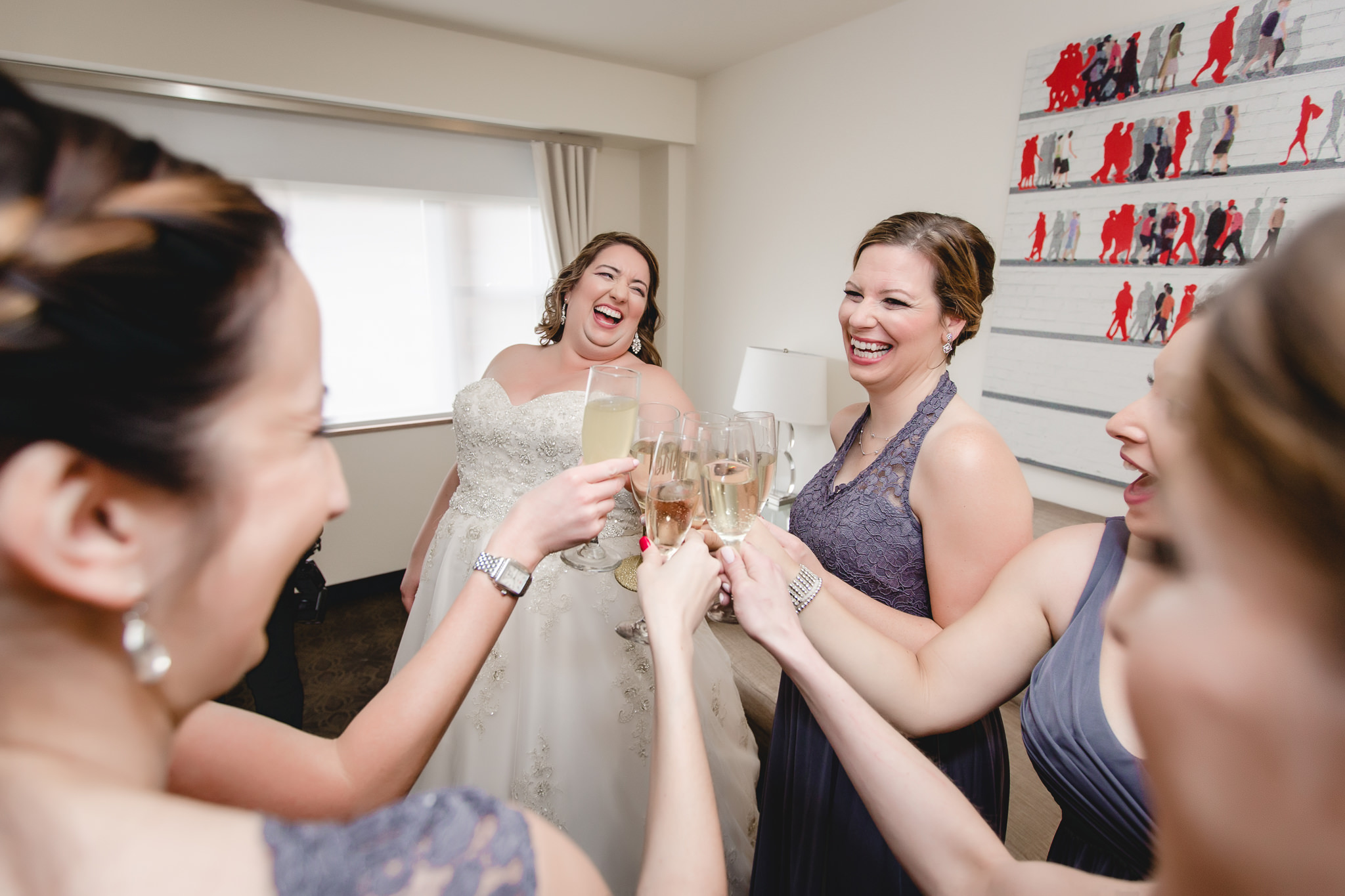 Bride toasts champagne with bridesmaids before a Pittsburgh wedding at Soldiers & Sailors
