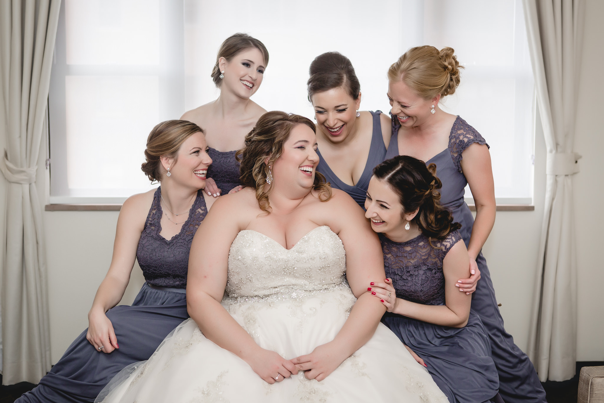 Bride laughing with bridesmaids before a Pittsburgh wedding at Soldiers & Sailors