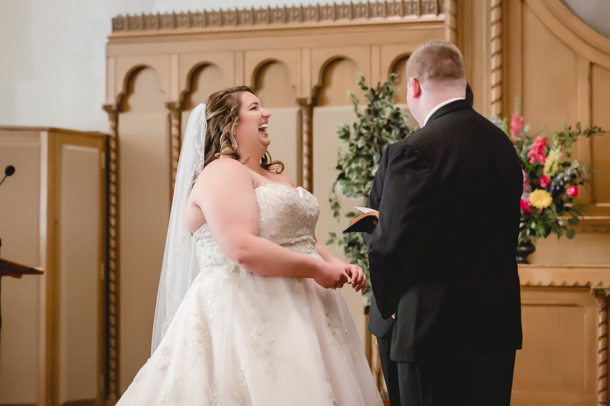 Bride laughs during ceremony at Bellefield Presbyterian in Pittsburgh