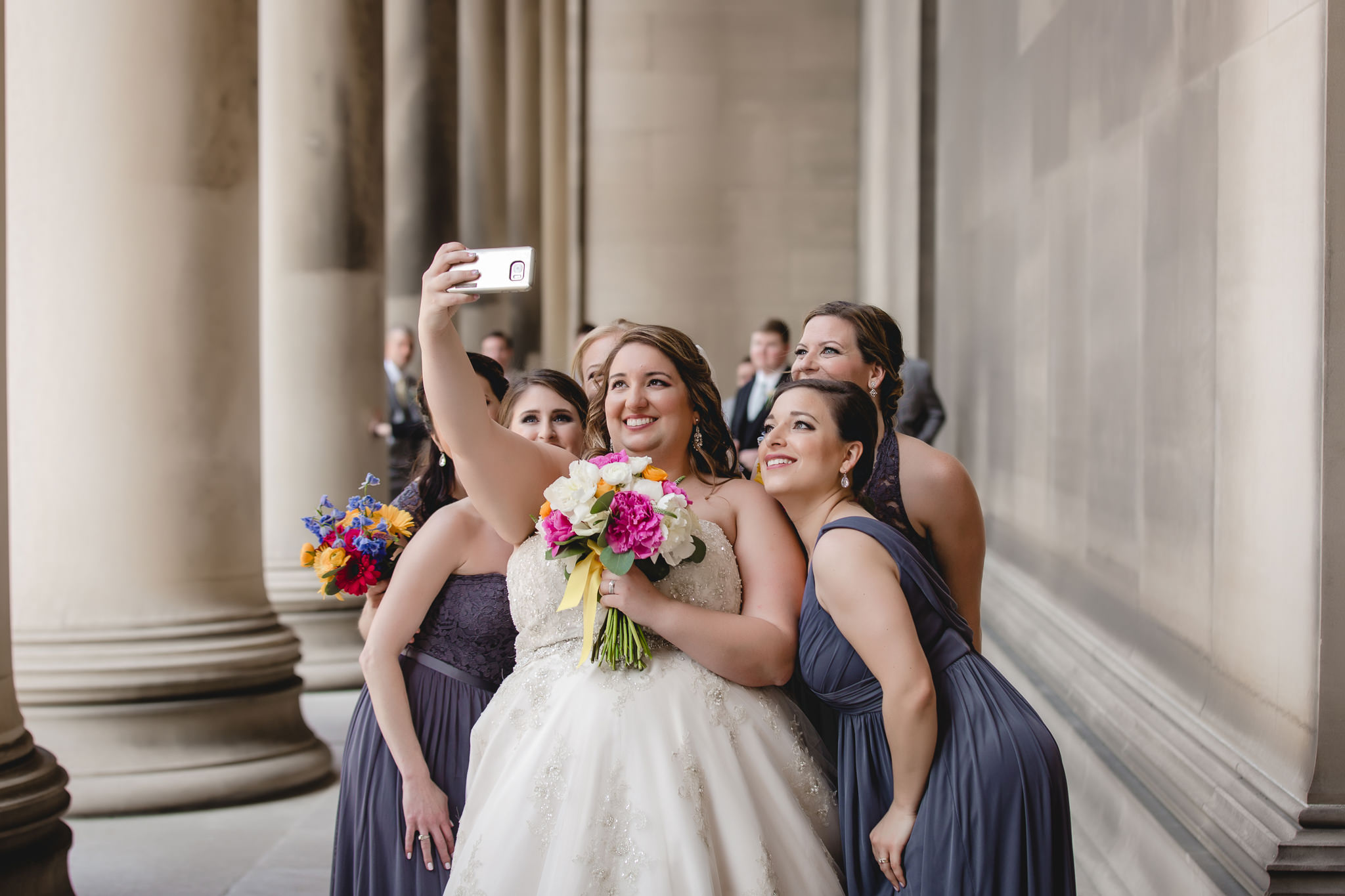 Bride takes a selfie with her bridesmaids before her Soldiers & Sailors wedding reception