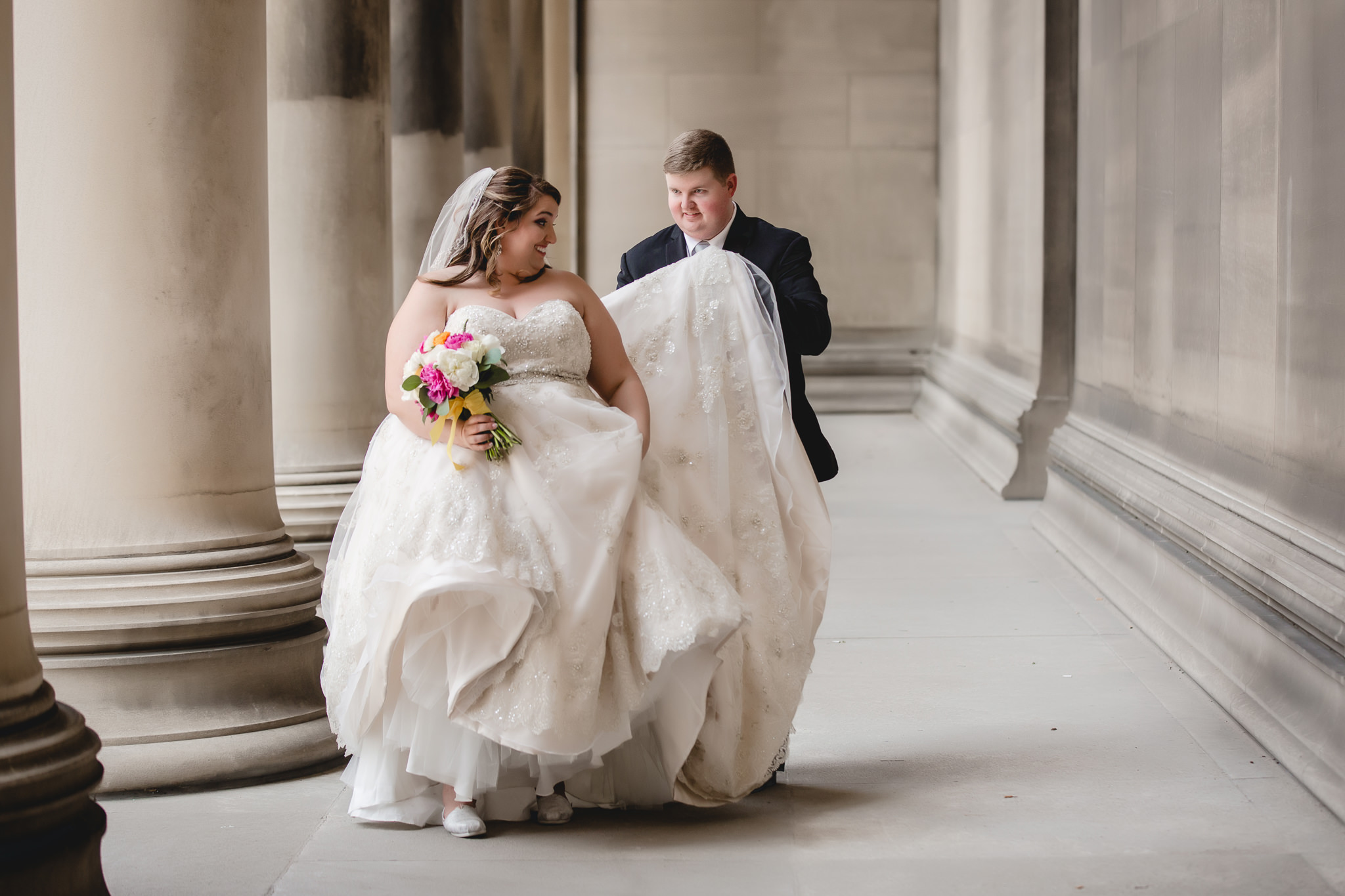 Groom helps bride walk to their Soldiers & Sailors wedding reception