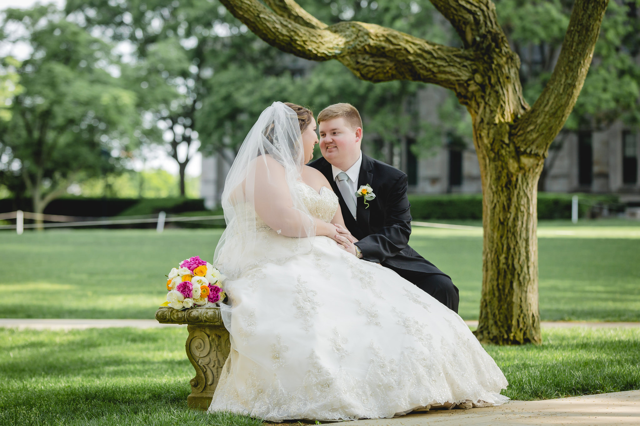 Bride & groom on a bench on the Heinz Chapel lawn in Pittsburgh