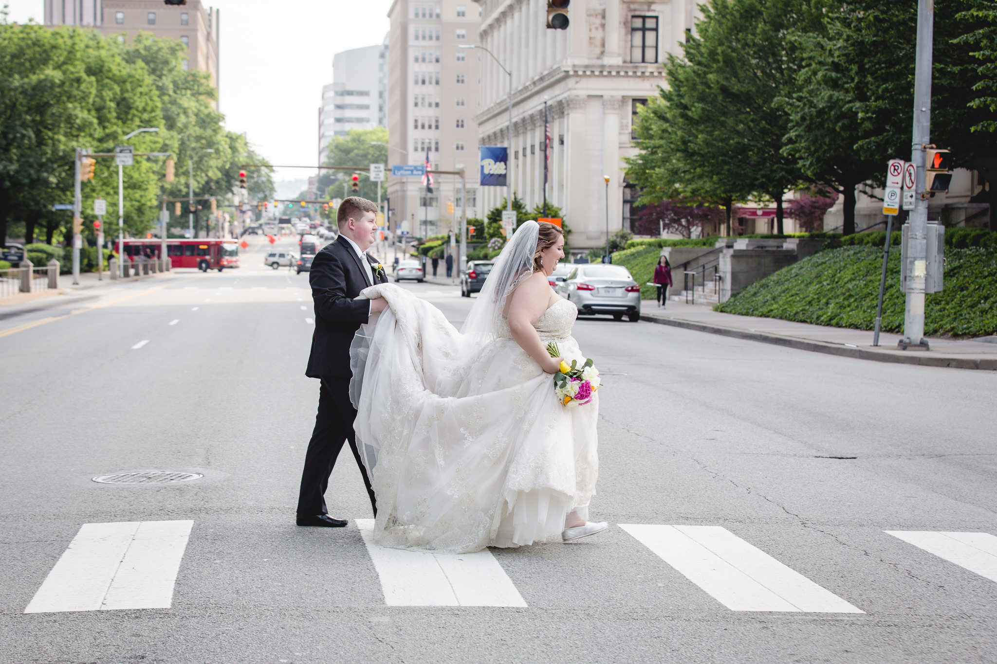 Bride and Groom in a crosswalk in Oakland near Soldiers & Sailors