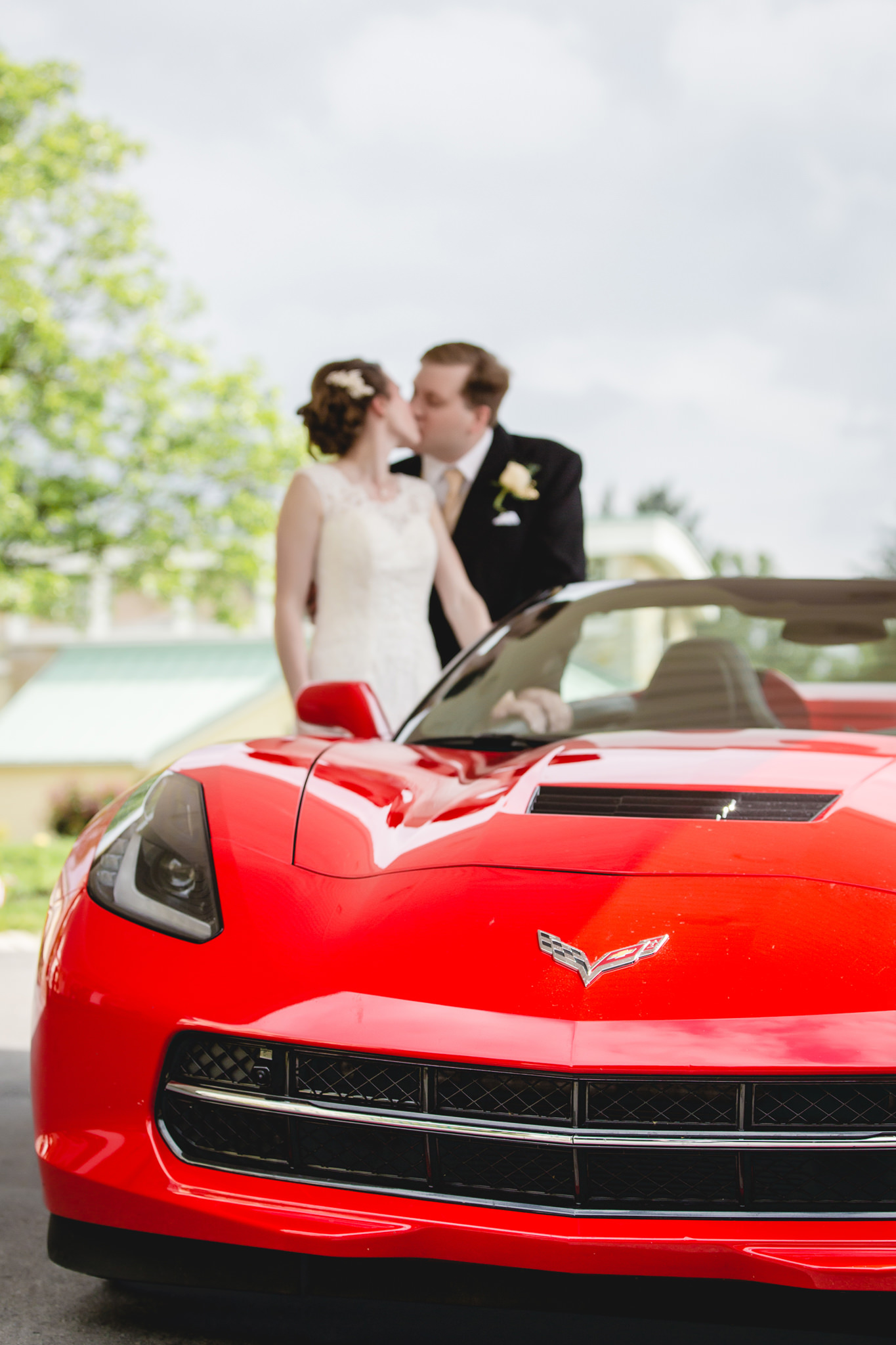 Bride & groom with their red Corvette at Shannopin Country Club