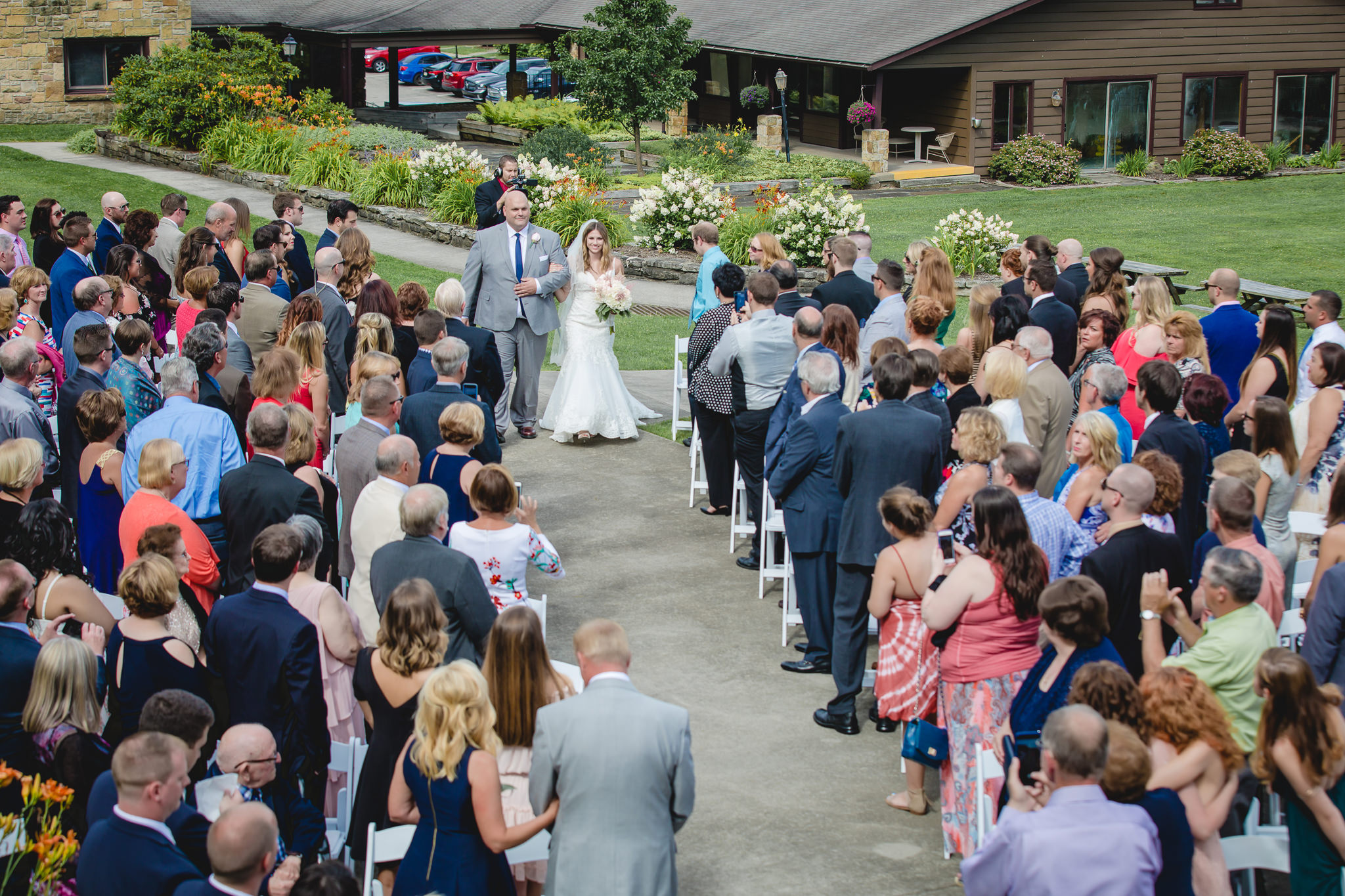 Father of the bride walks his daughter down the aisle at Hidden Valley Resort