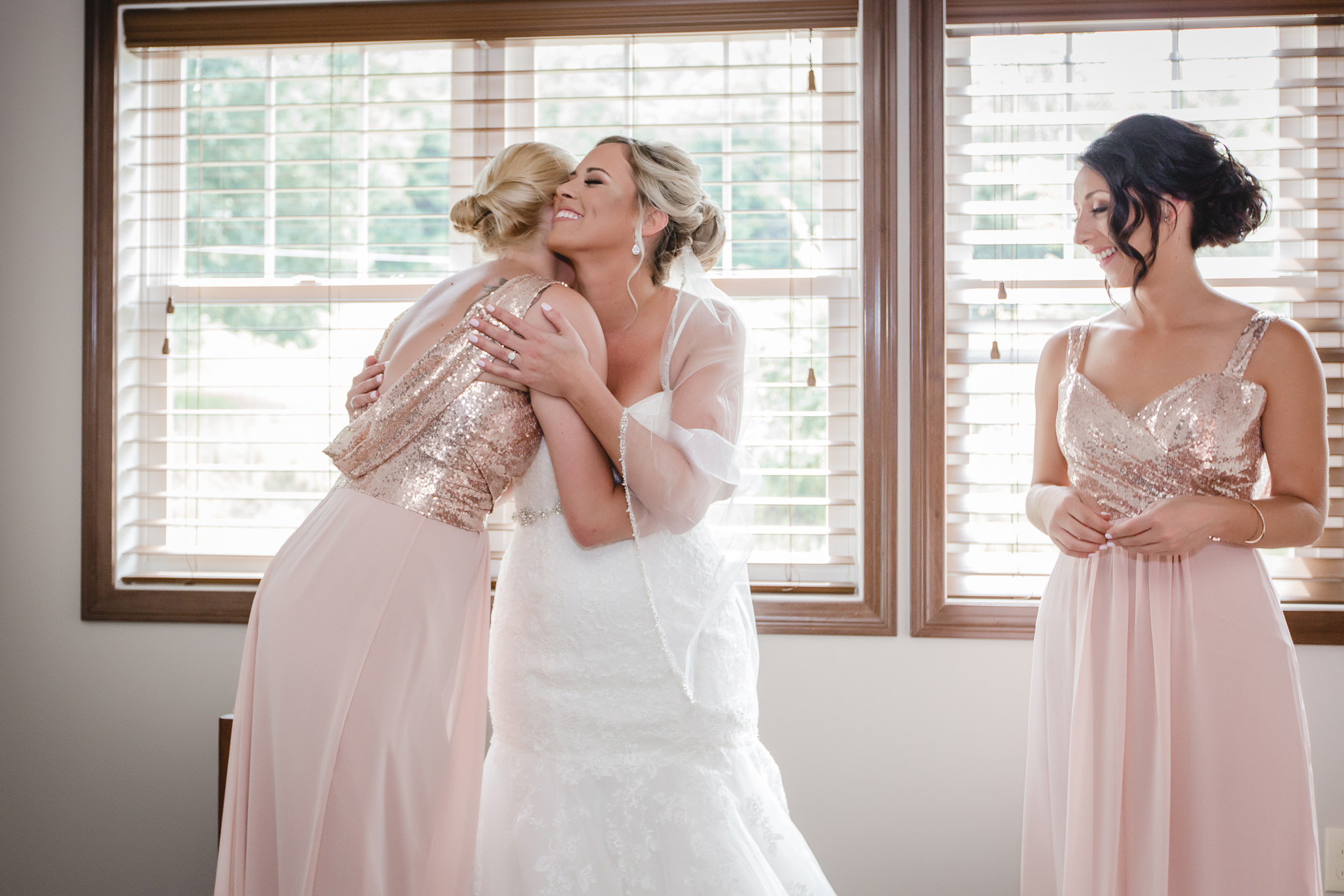Bride shares a hug with her bridesmaid before her Gathering Place at Darlington Lake wedding