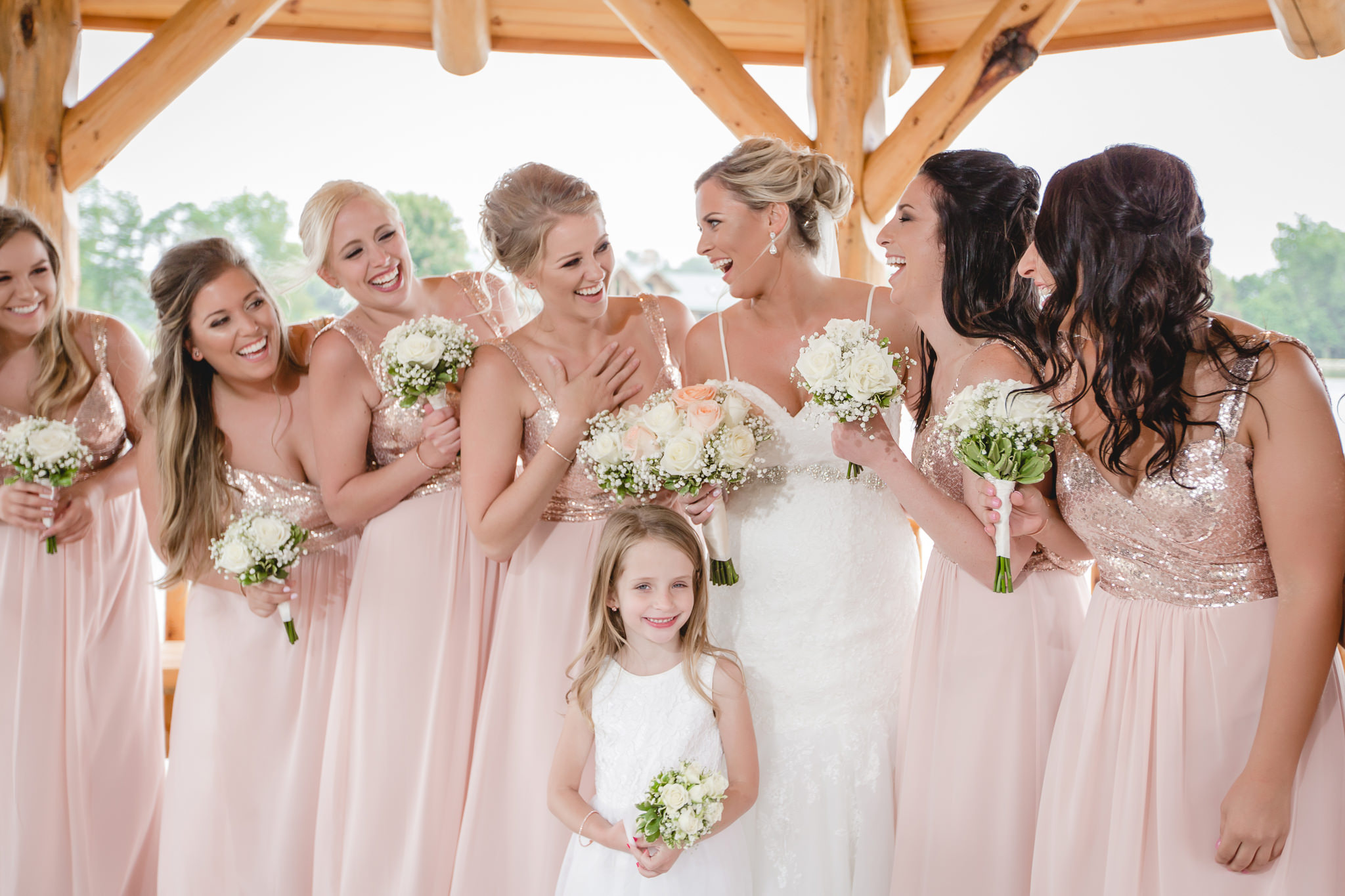 Bride laughs with her bridesmaids at the Gathering Place at Darlington Lake