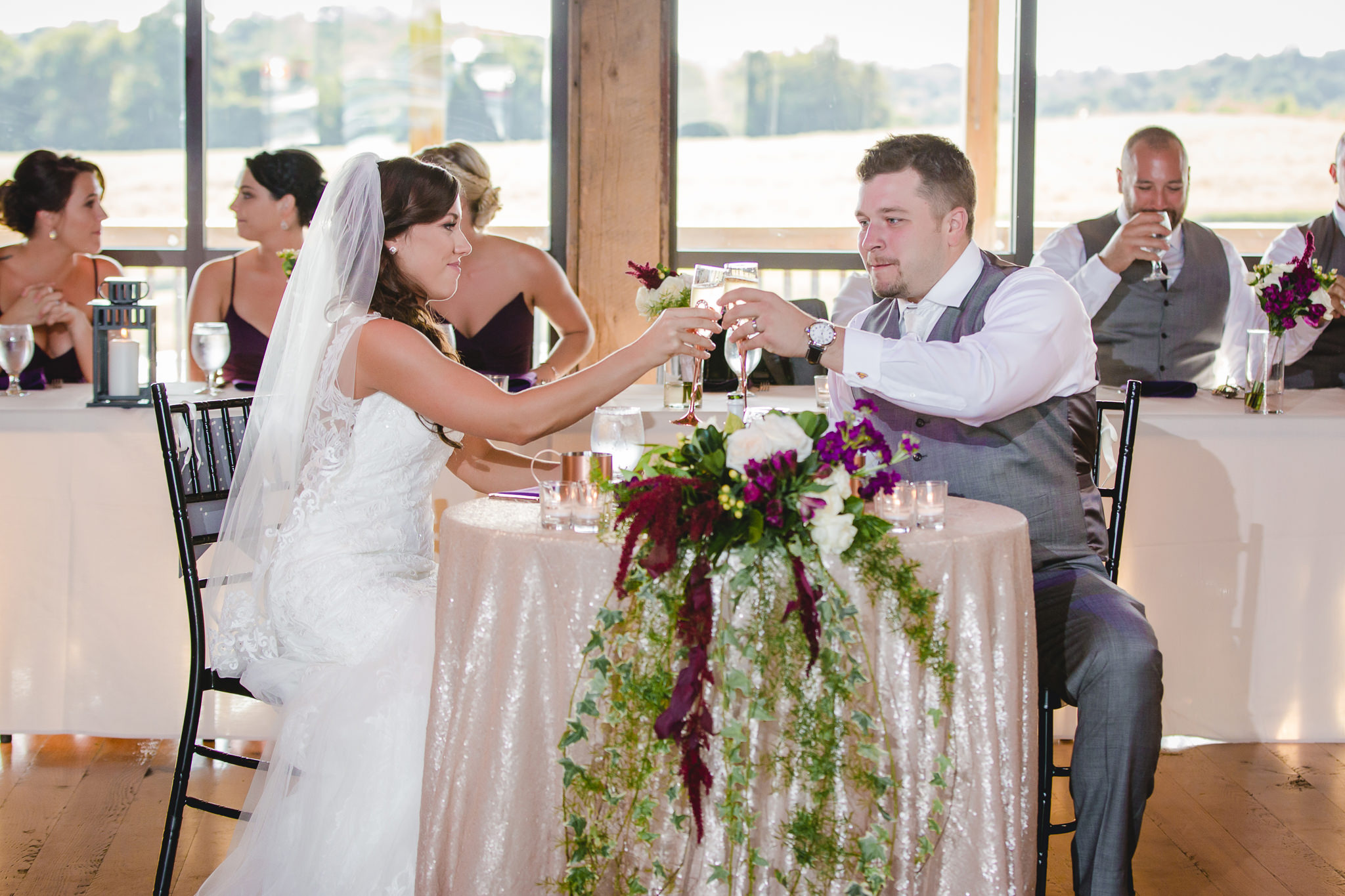 Bride and groom toast each other at White Barn