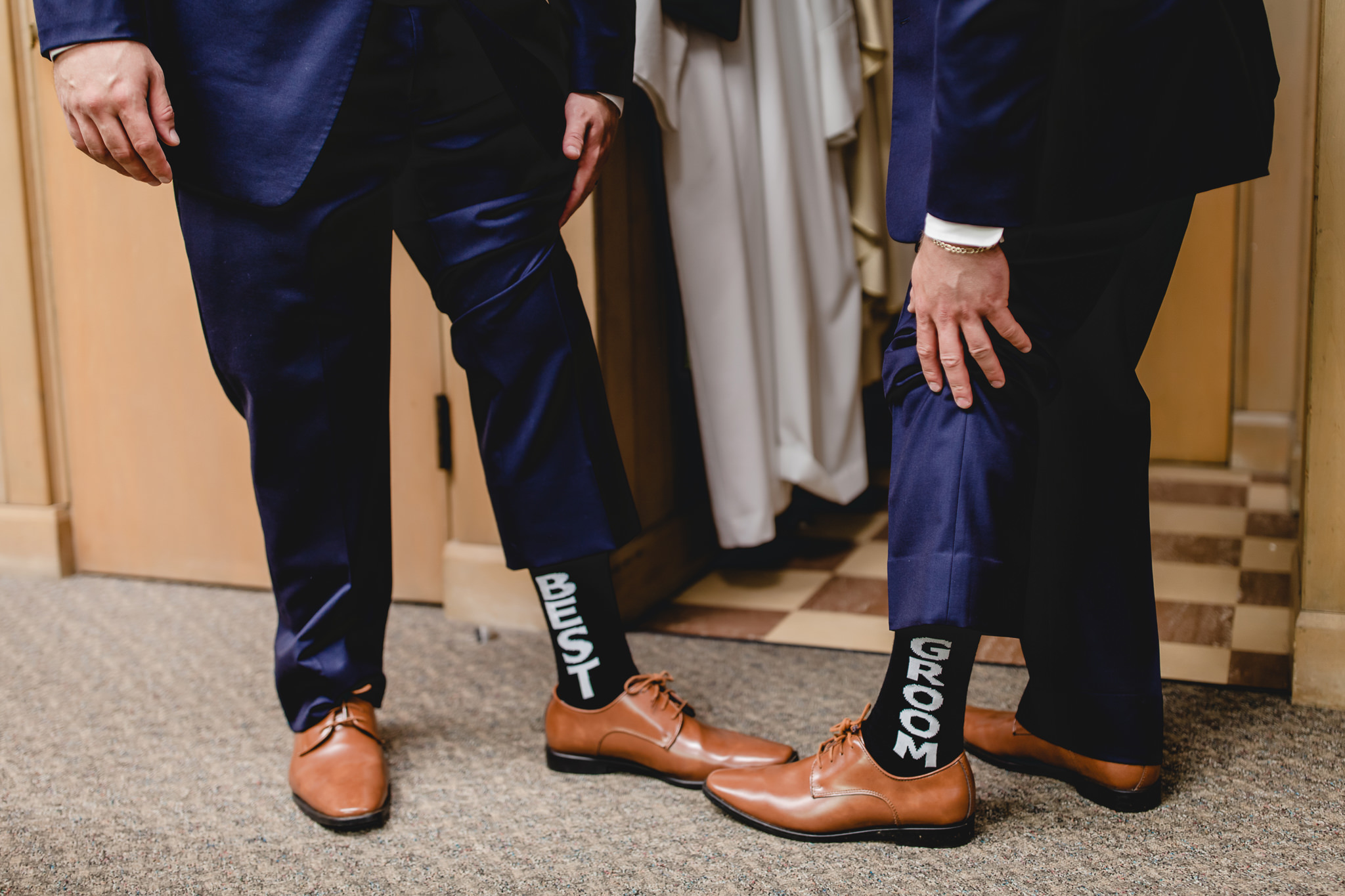Groom and best man show off their socks at St. Titus Church