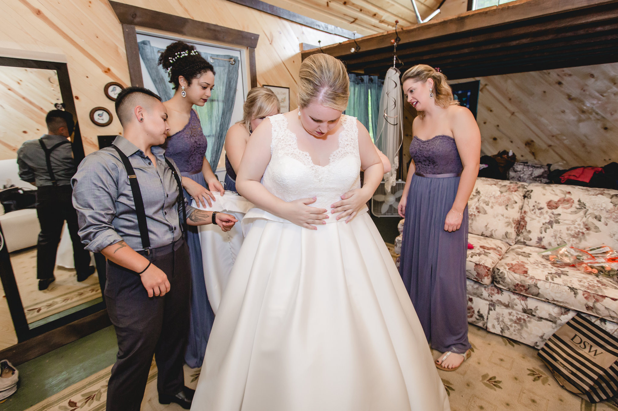 Bridesmaids help the bride into her Essense of Australia wedding dress
