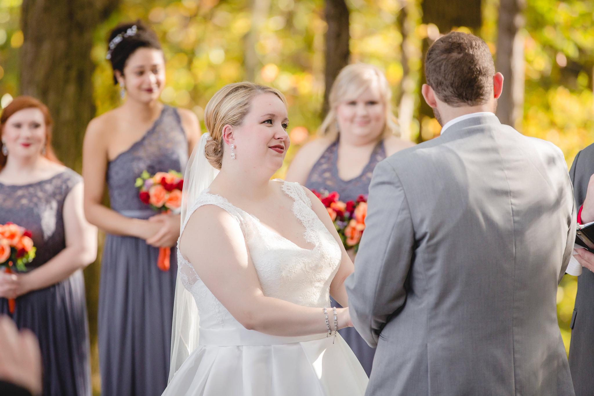 Bride gazes at her groom during their Barn at Soergel Hollow wedding ceremony