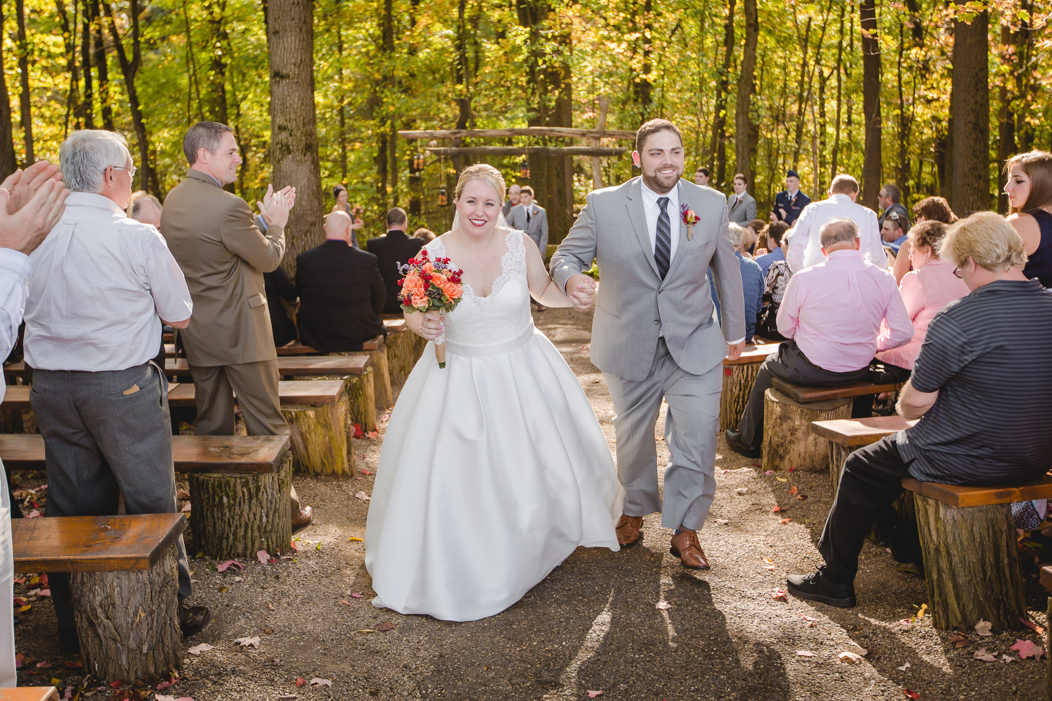 Newlyweds exit their rustic outdoor ceremony at the Barn at Soergel Hollow