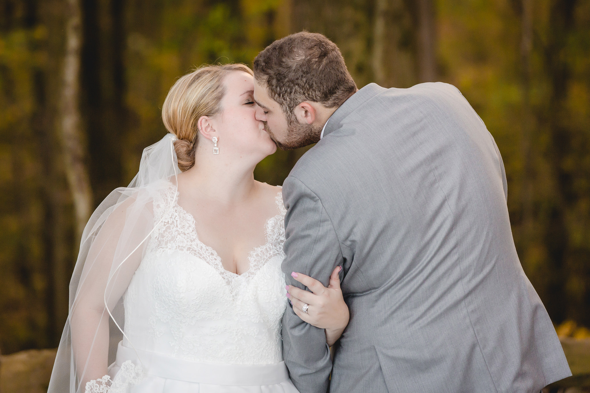 Newlyweds kiss during portraits at the Barn at Soergel Hollow