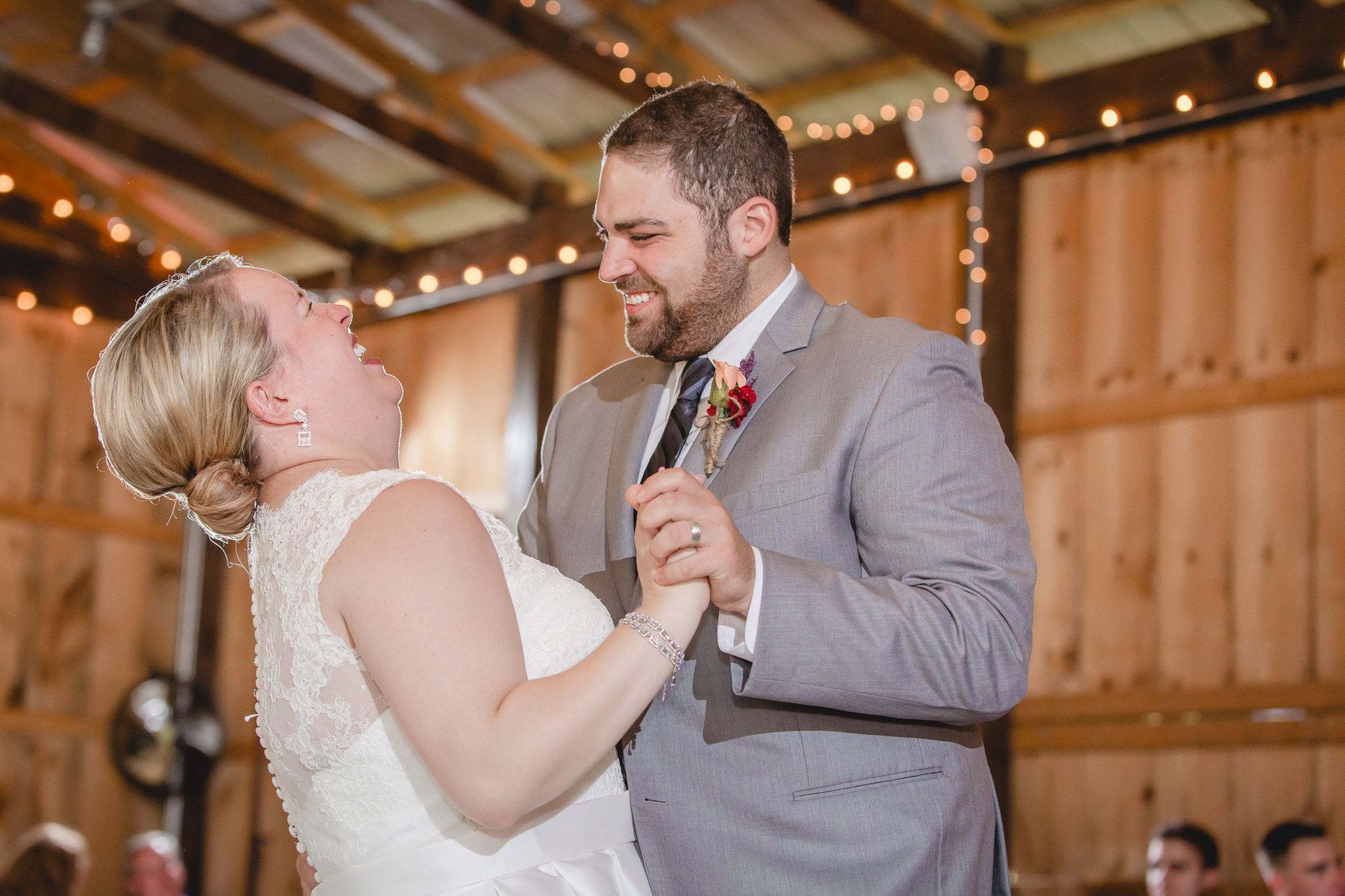 Bride and groom laugh during their first dance at the Barn at Soergel Hollow