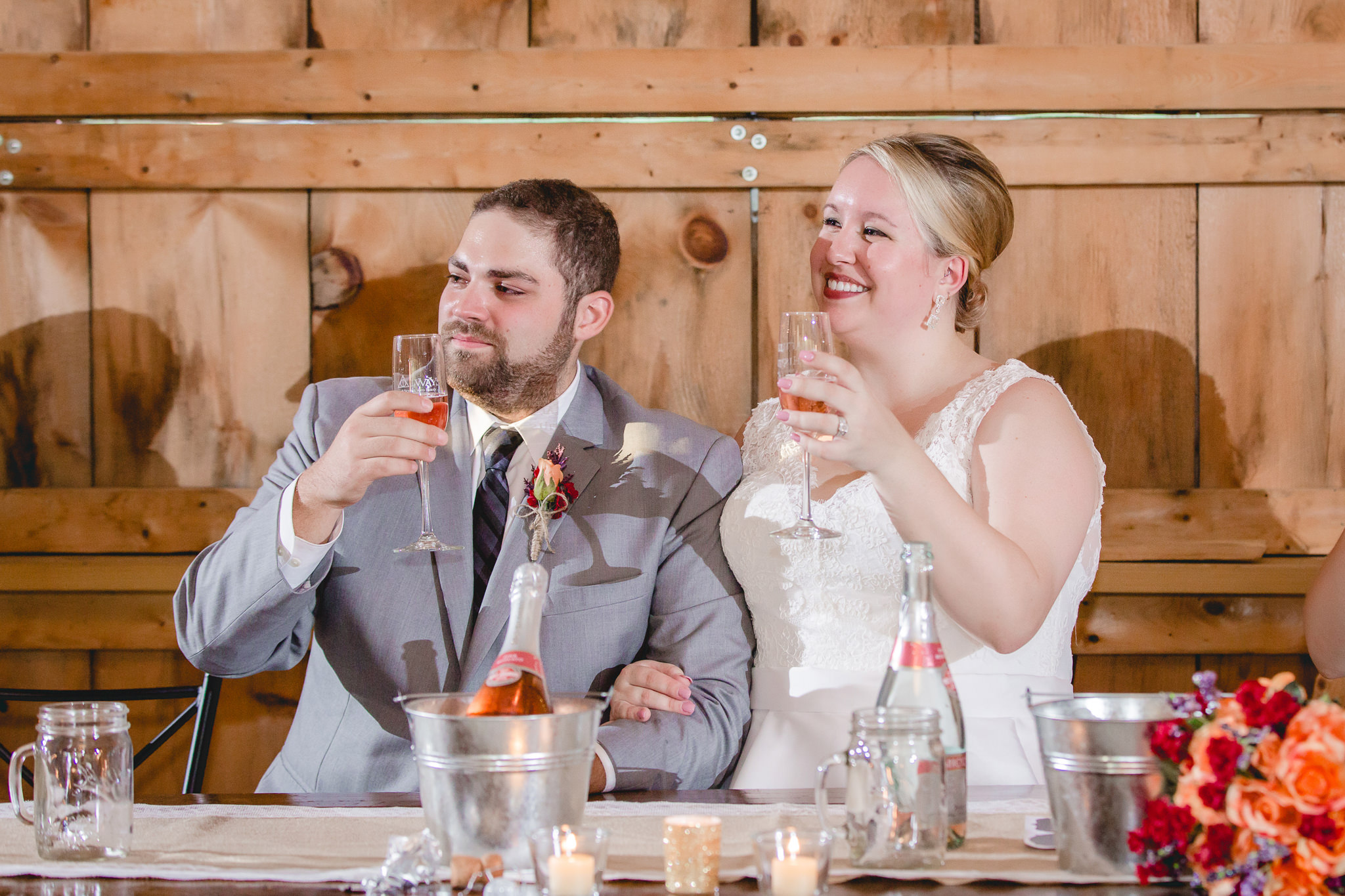 Bride and groom toast each other at their Barn at Soergel Hollow wedding reception