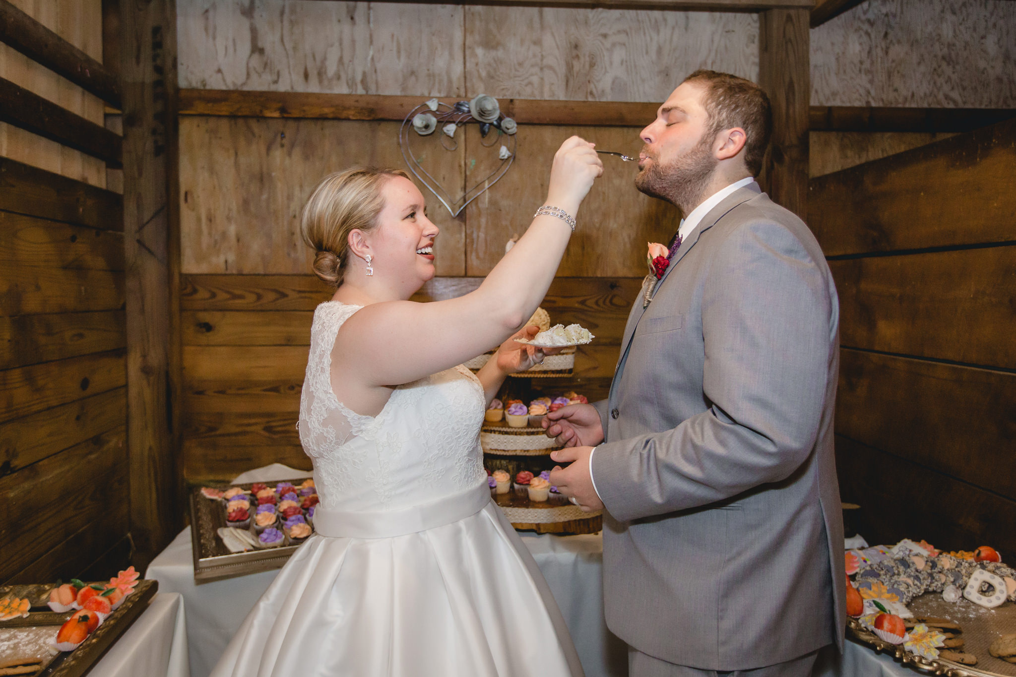 Bride feeds the groom a piece of cake at the Barn at Soergel Hollow