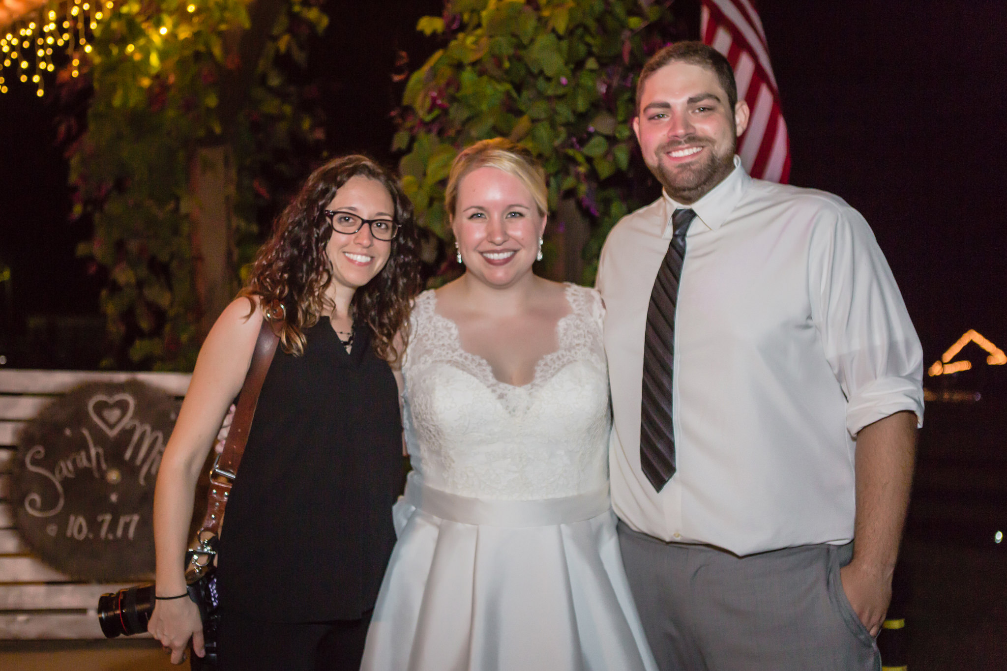 Bride and groom pose with their wedding photographer Kristen Vota at the Barn at Soergel Hollow