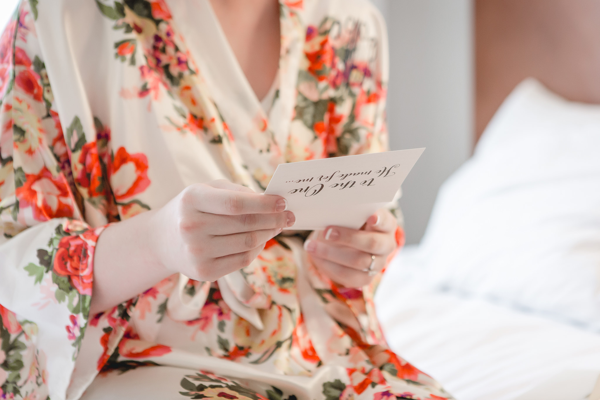 Bride reads a note from her groom before their wedding at the Chadwick