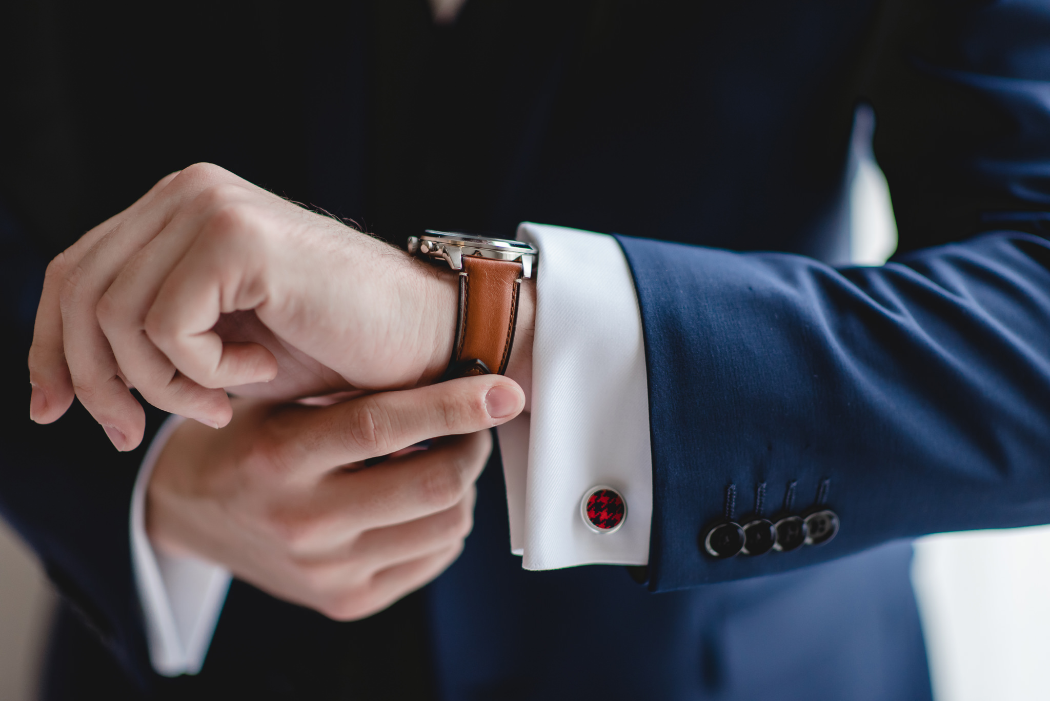 Groom checks his watch before his wedding at the Chadwick