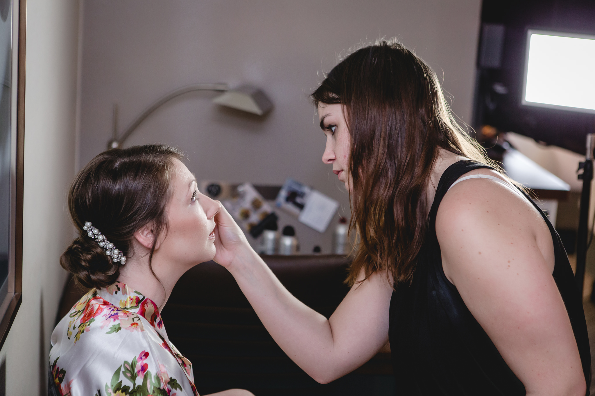 Bride getting her makeup done before her wedding at the Chadwick