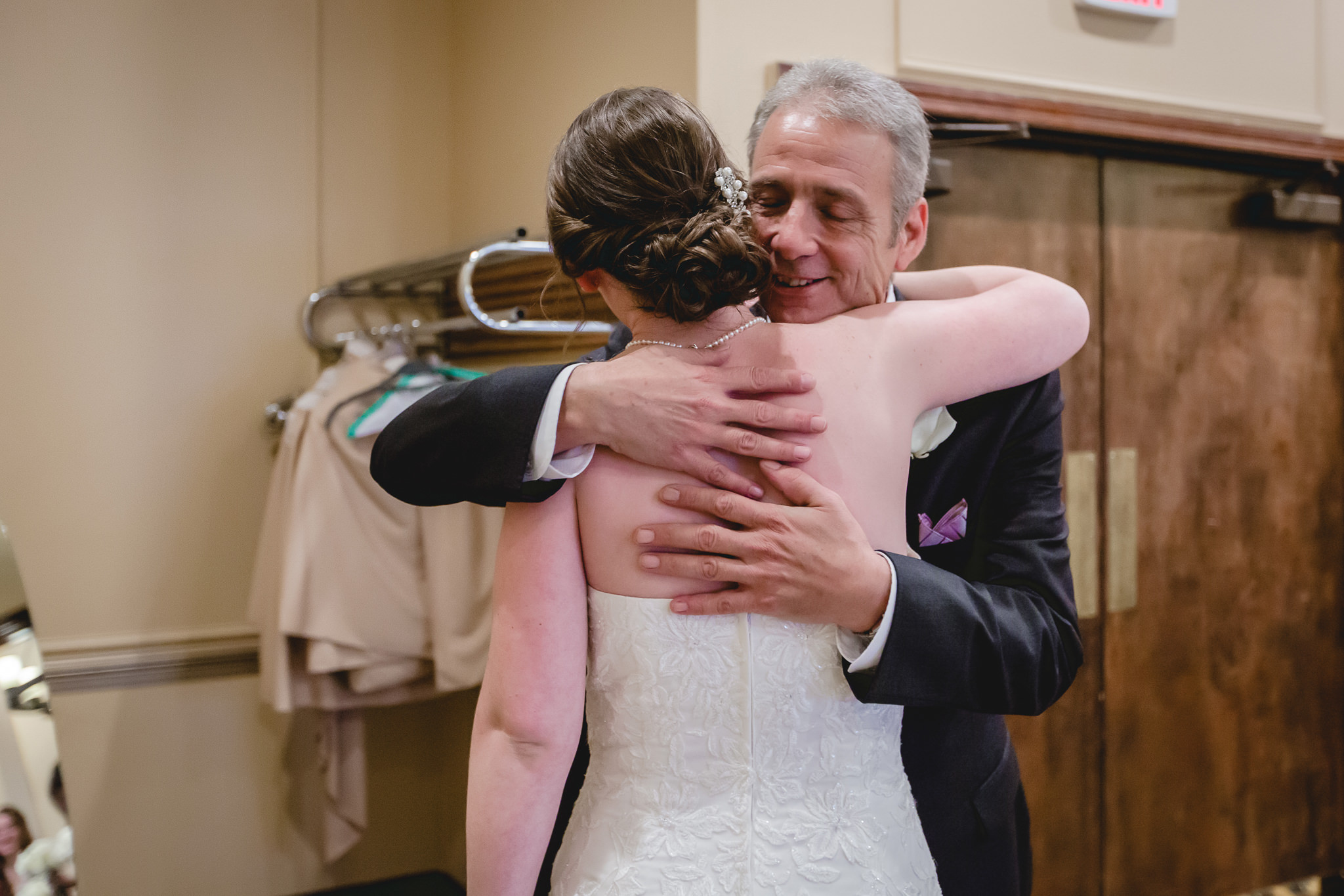 Father of the bride hugs his daughter before walking her down the aisle at the Chadwick