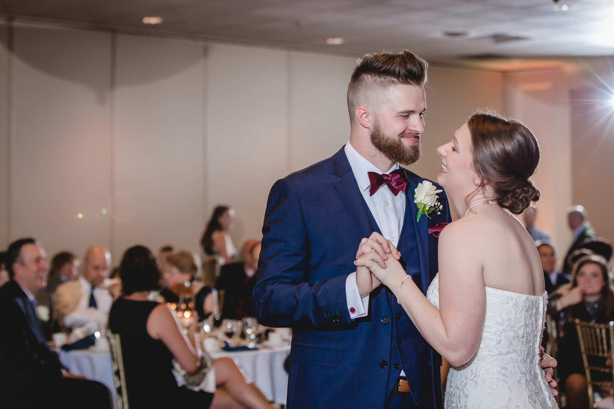 Groom smiles at his bride during their first dance at the Chadwick
