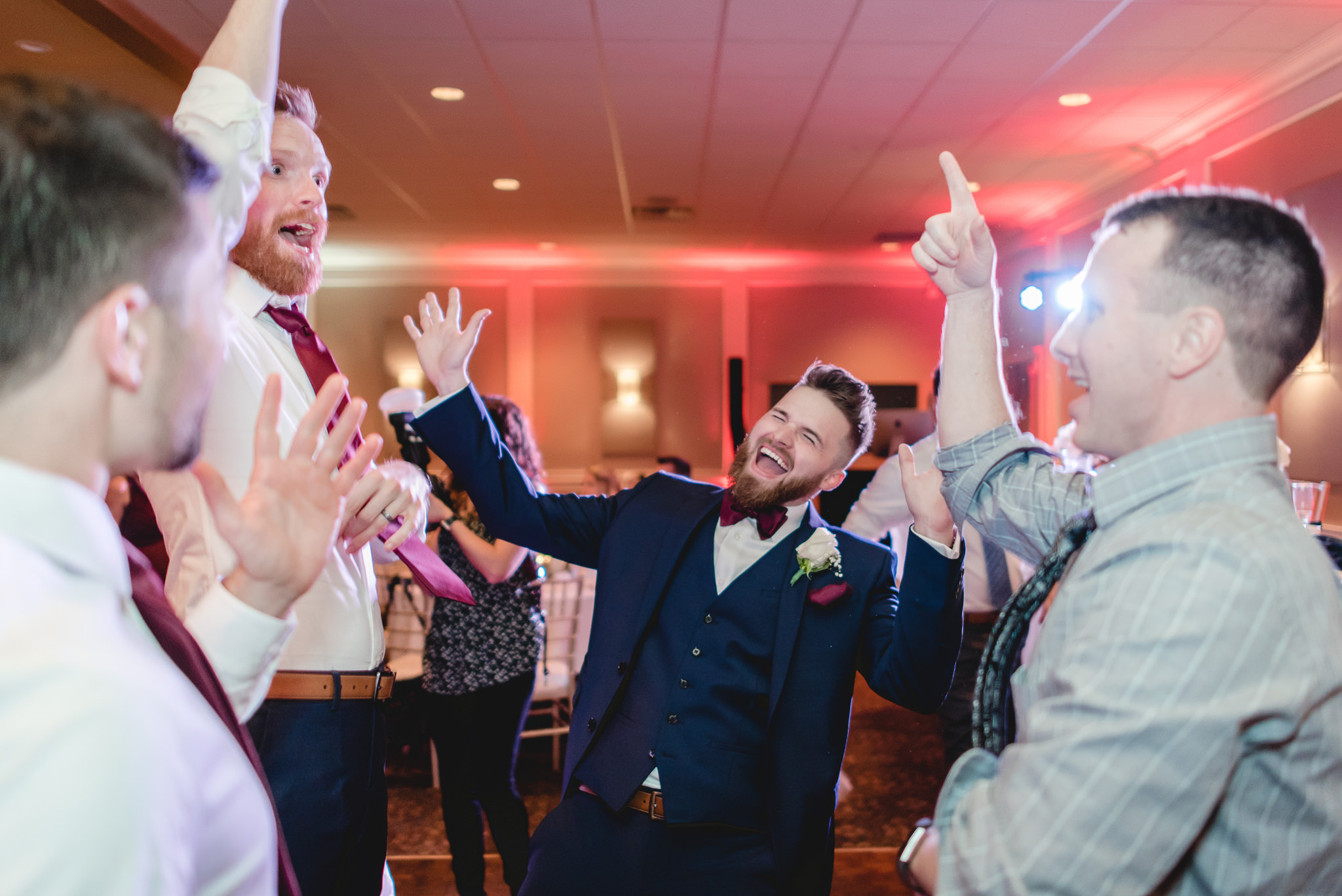 Groom dances with friends at his wedding reception at the Chadwick