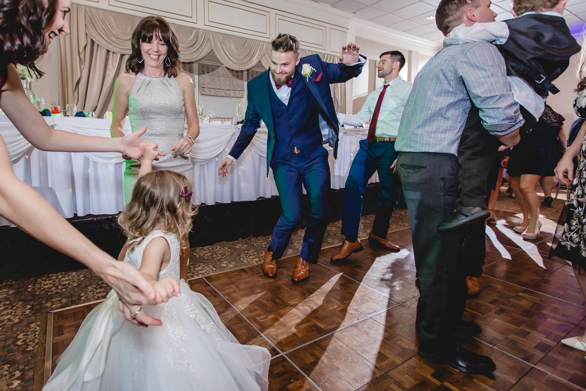 Groom dances with the flower girl at his wedding at the Chadwick