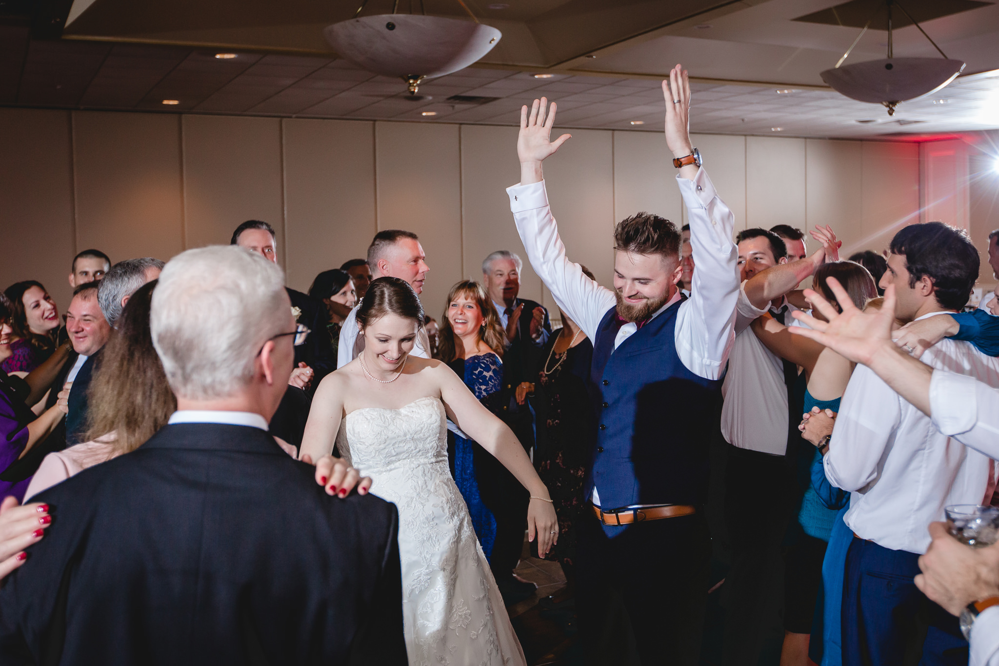 Bride and groom dance with guests at their Chadwick wedding reception