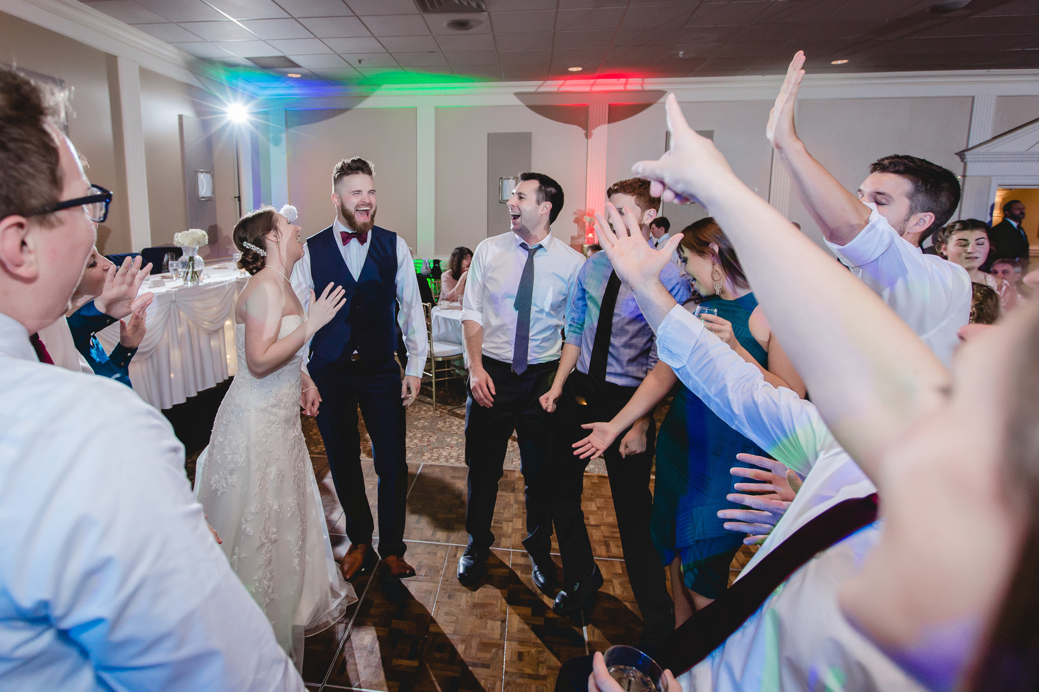 Bride and groom laugh while dancing at their wedding at the Chadwick