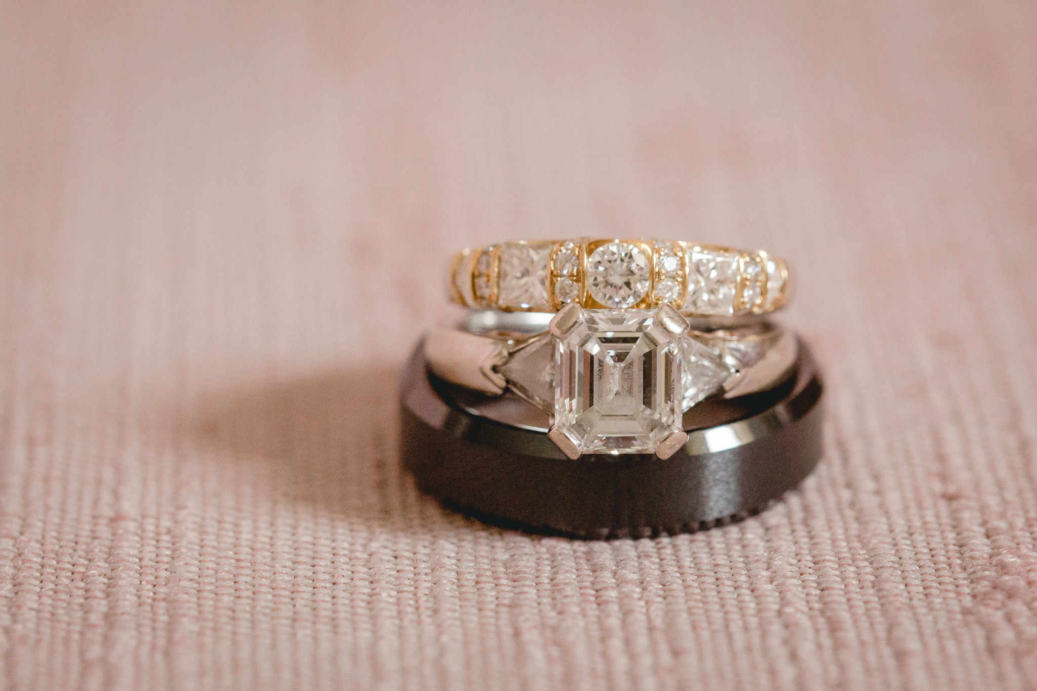 Closeup macro photo of engagement ring and wedding bands