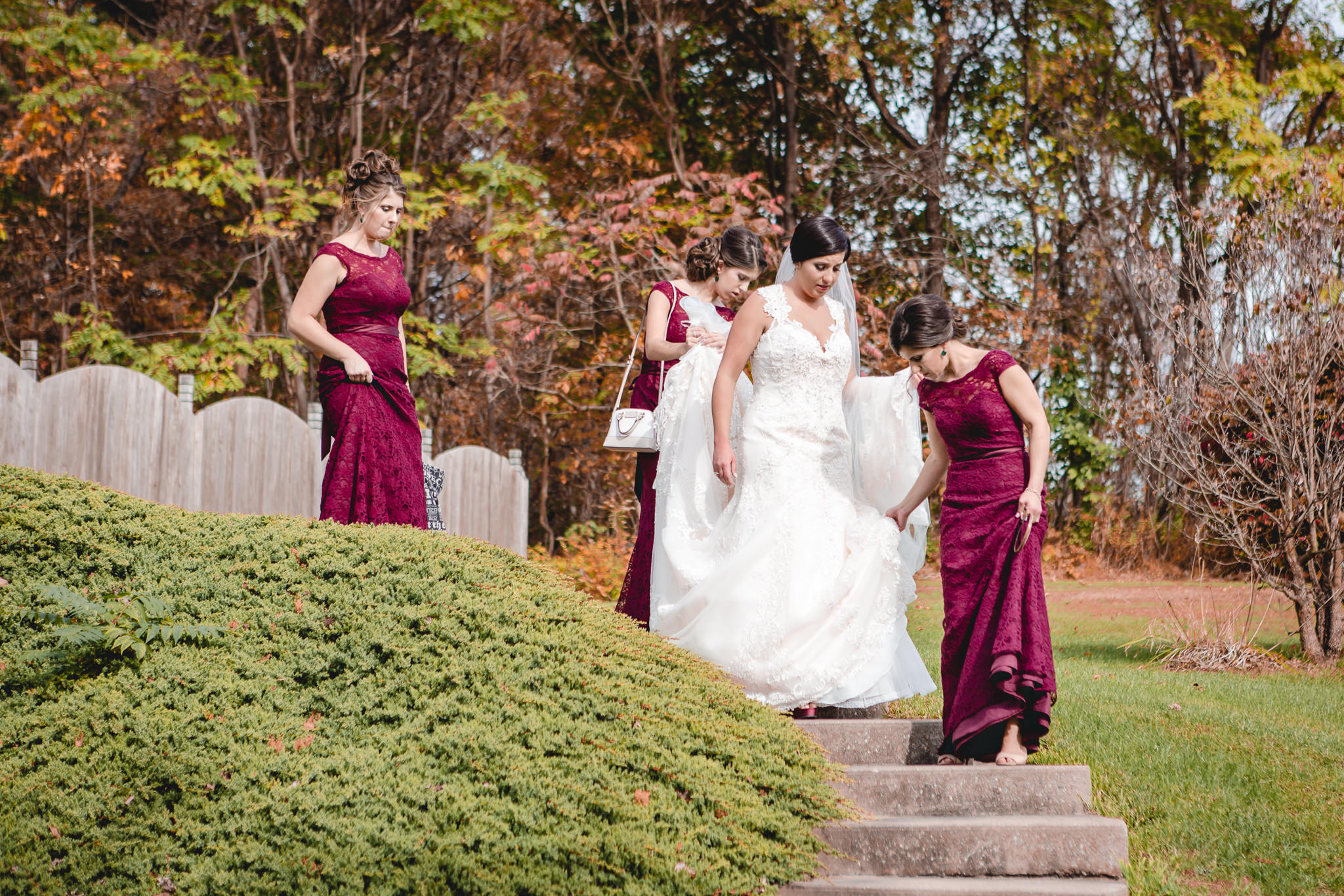Bridesmaids help the bride down the steps on the way to the DoubleTree Pittsburgh Airport