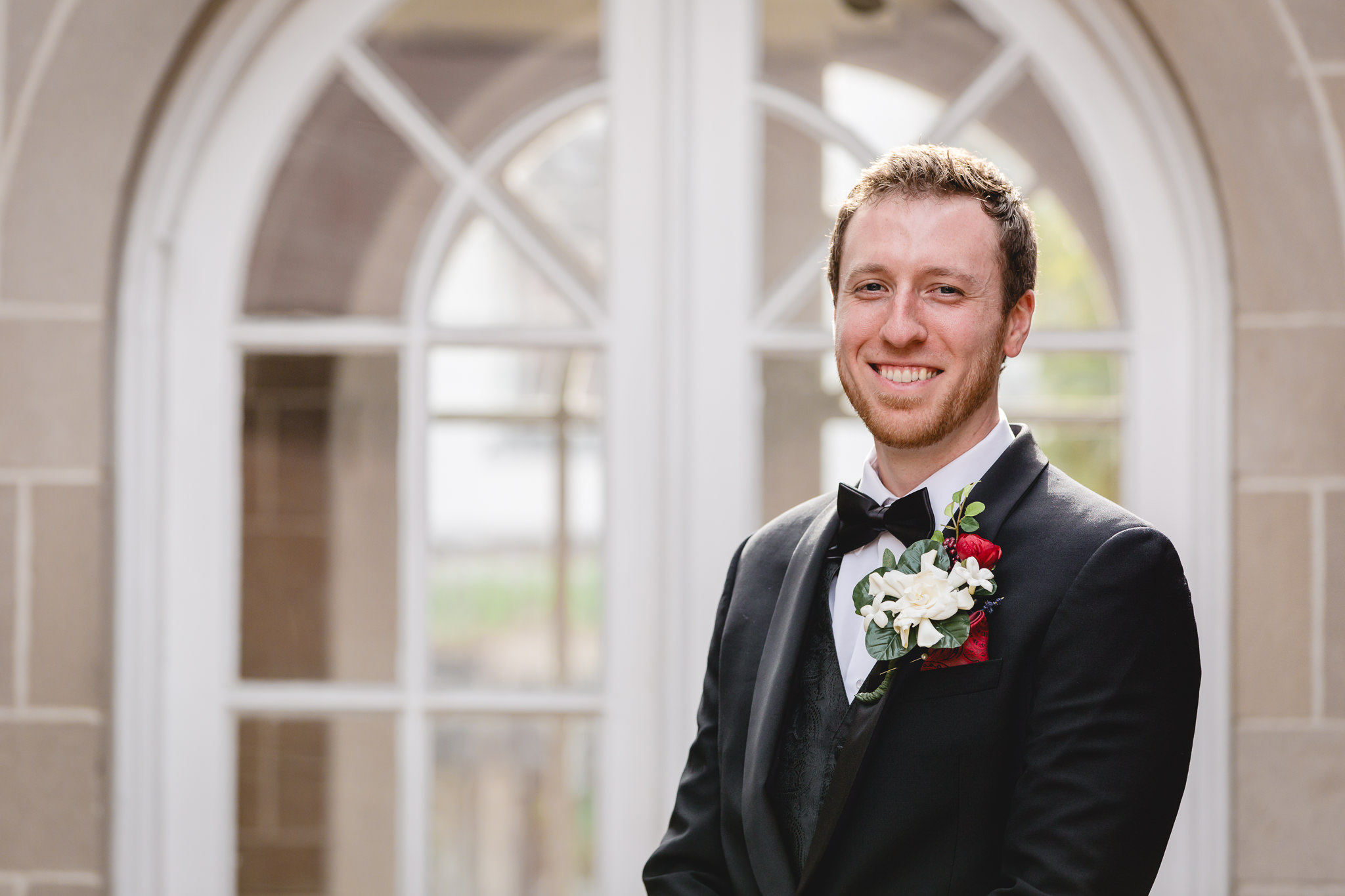Groom poses for a portrait before his wedding at St. John the Baptist in Monaca