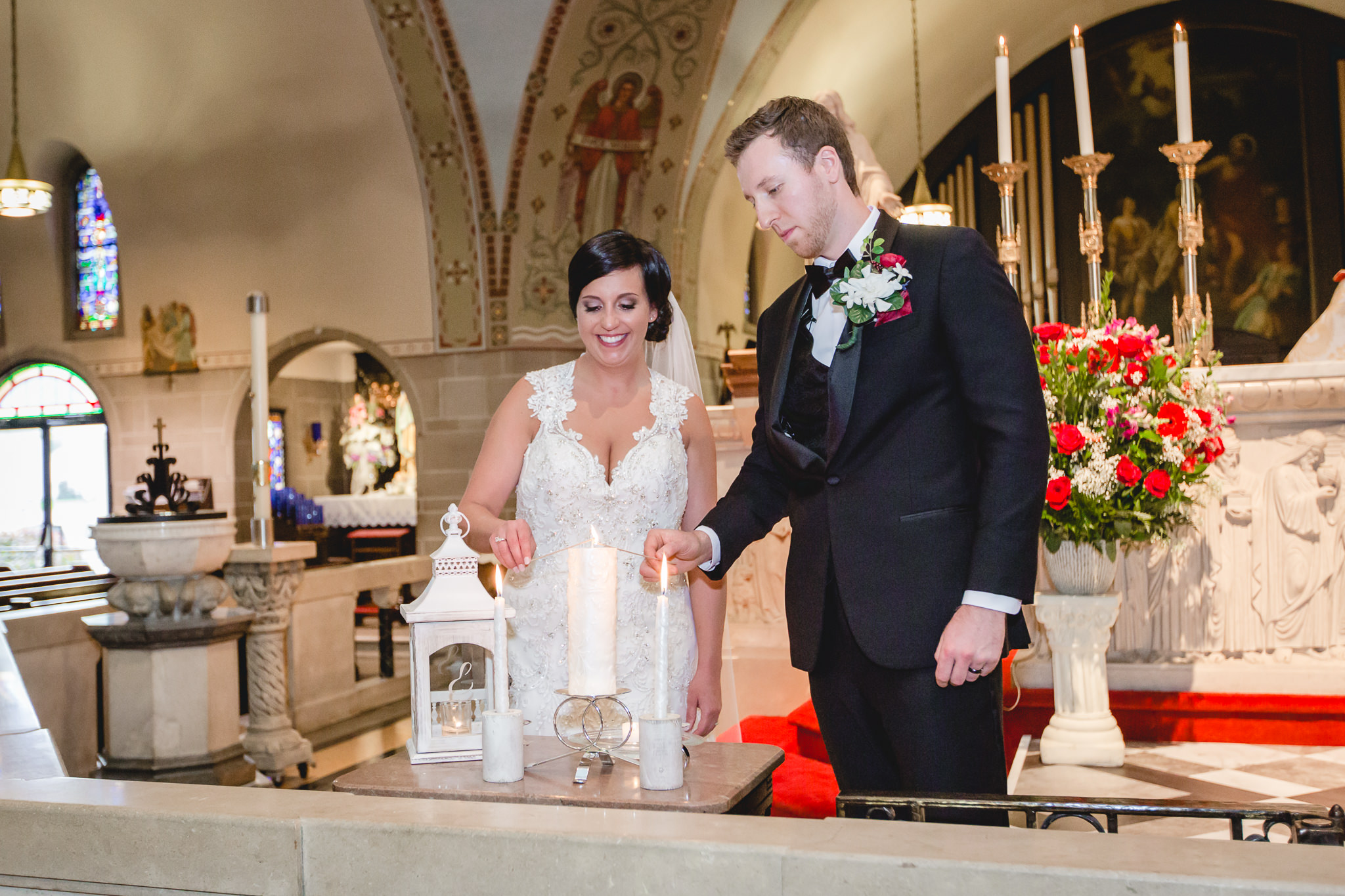 Bride and groom light the unity candle at St. John the Baptist in Monaca