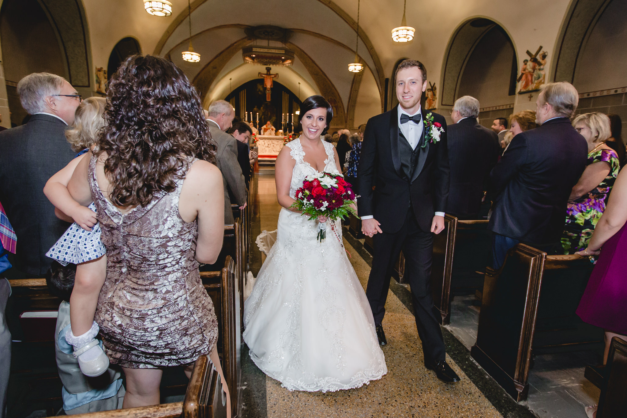 Newlyweds exit their wedding ceremony at St. John the Baptist