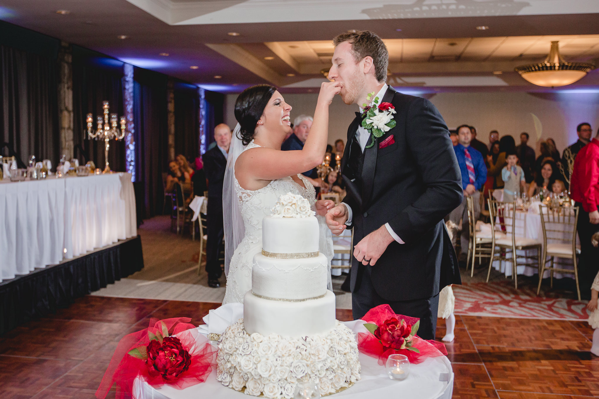 Bride feeds the groom some cake at DoubleTree Pittsburgh Airport