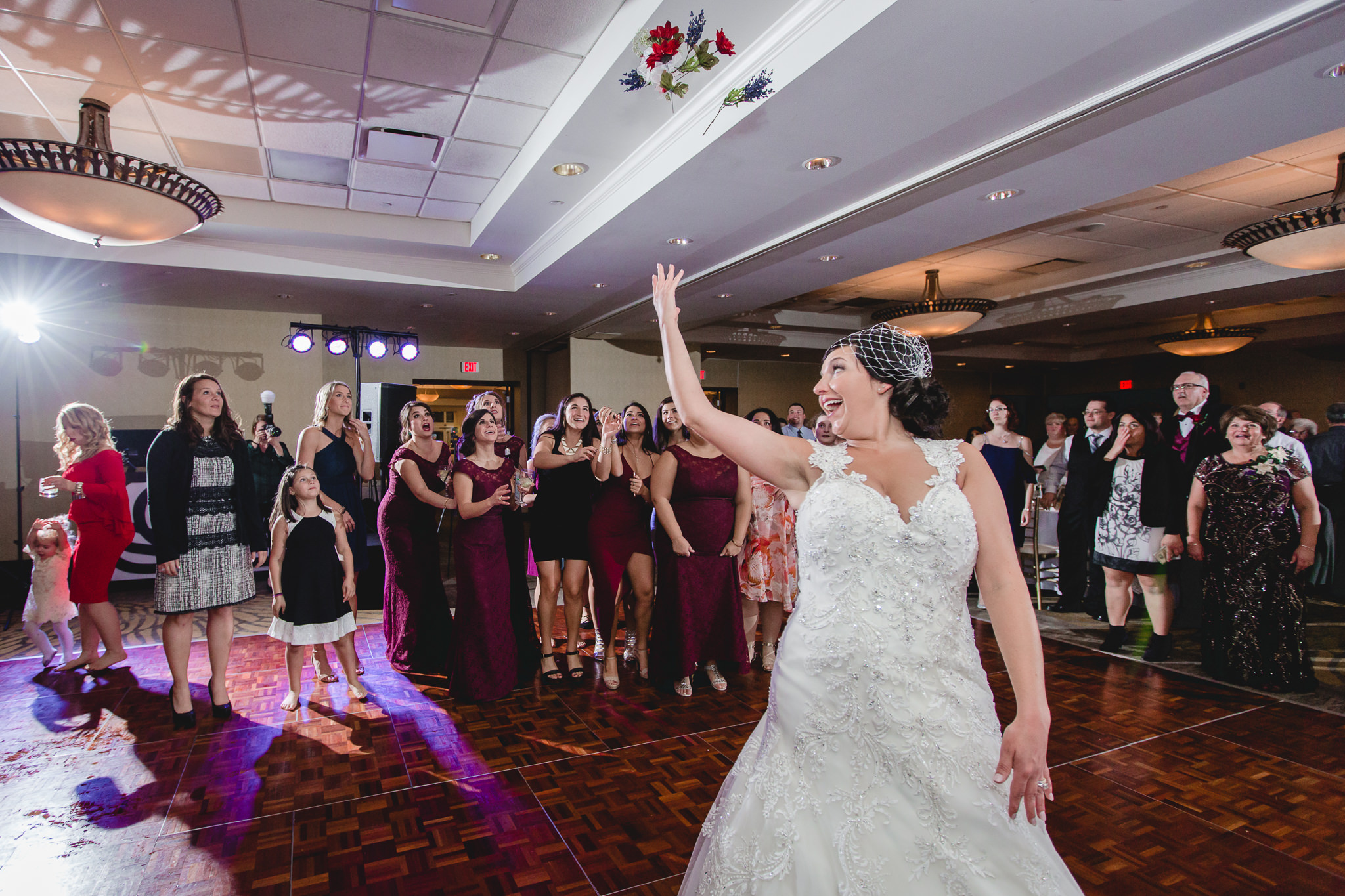 Bride tosses her bouquet at her DoubleTree Pittsburgh Airport wedding reception