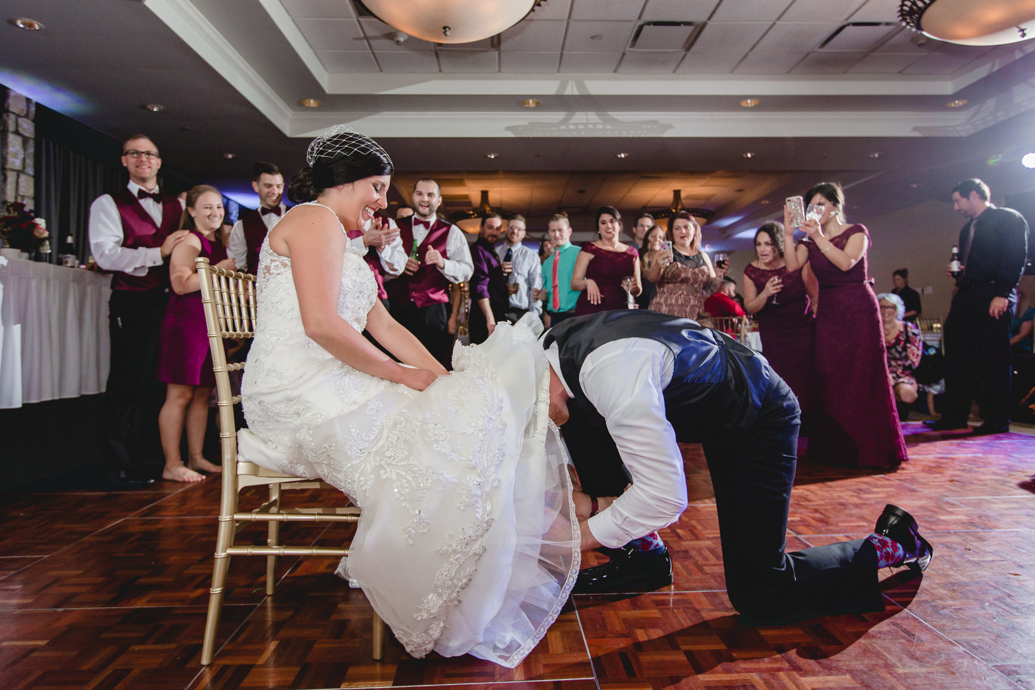Groom removes the bride's garter at their DoubleTree Pittsburgh Airport wedding