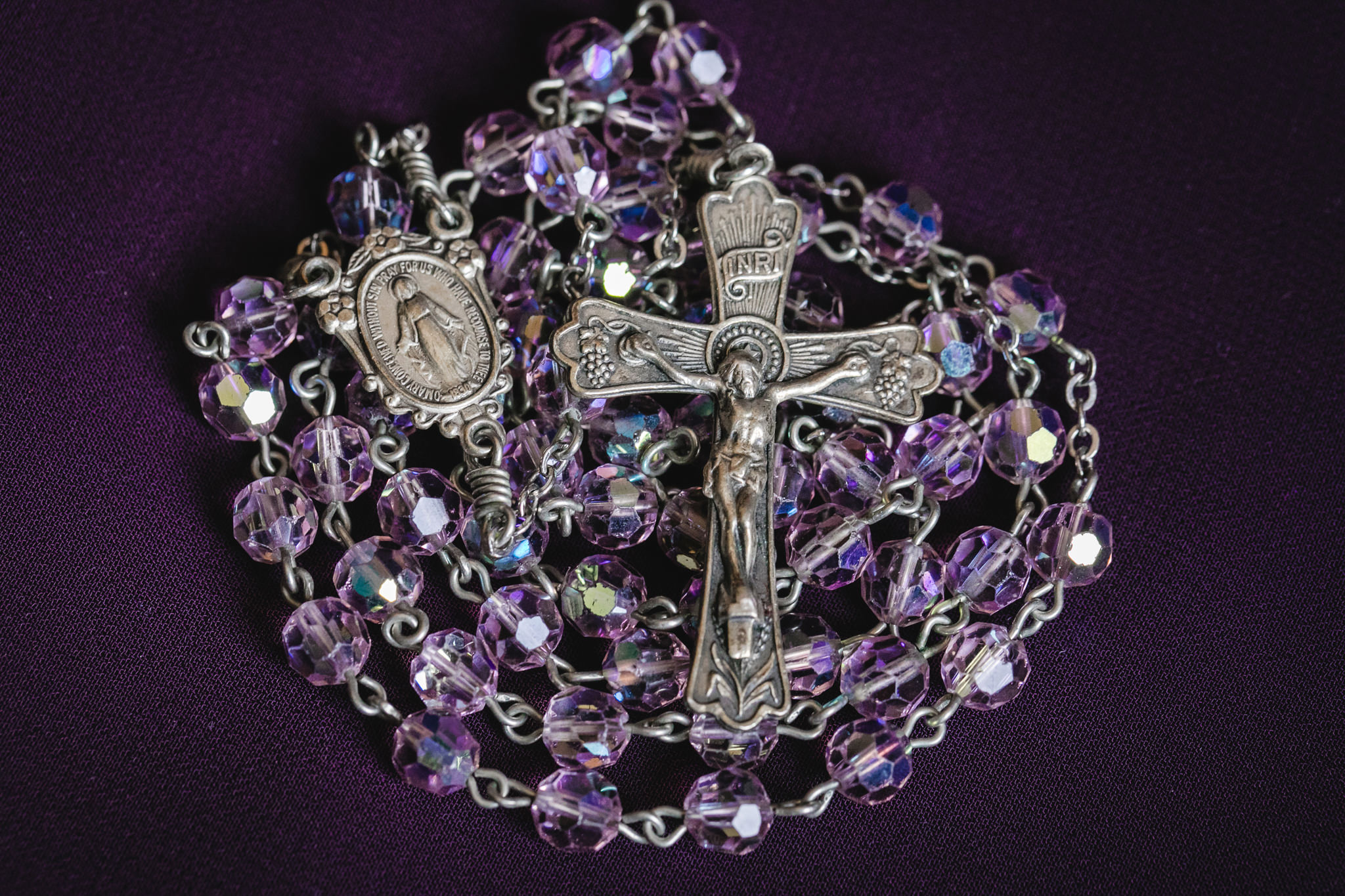 Bride's purple rosary beads for her bouquet