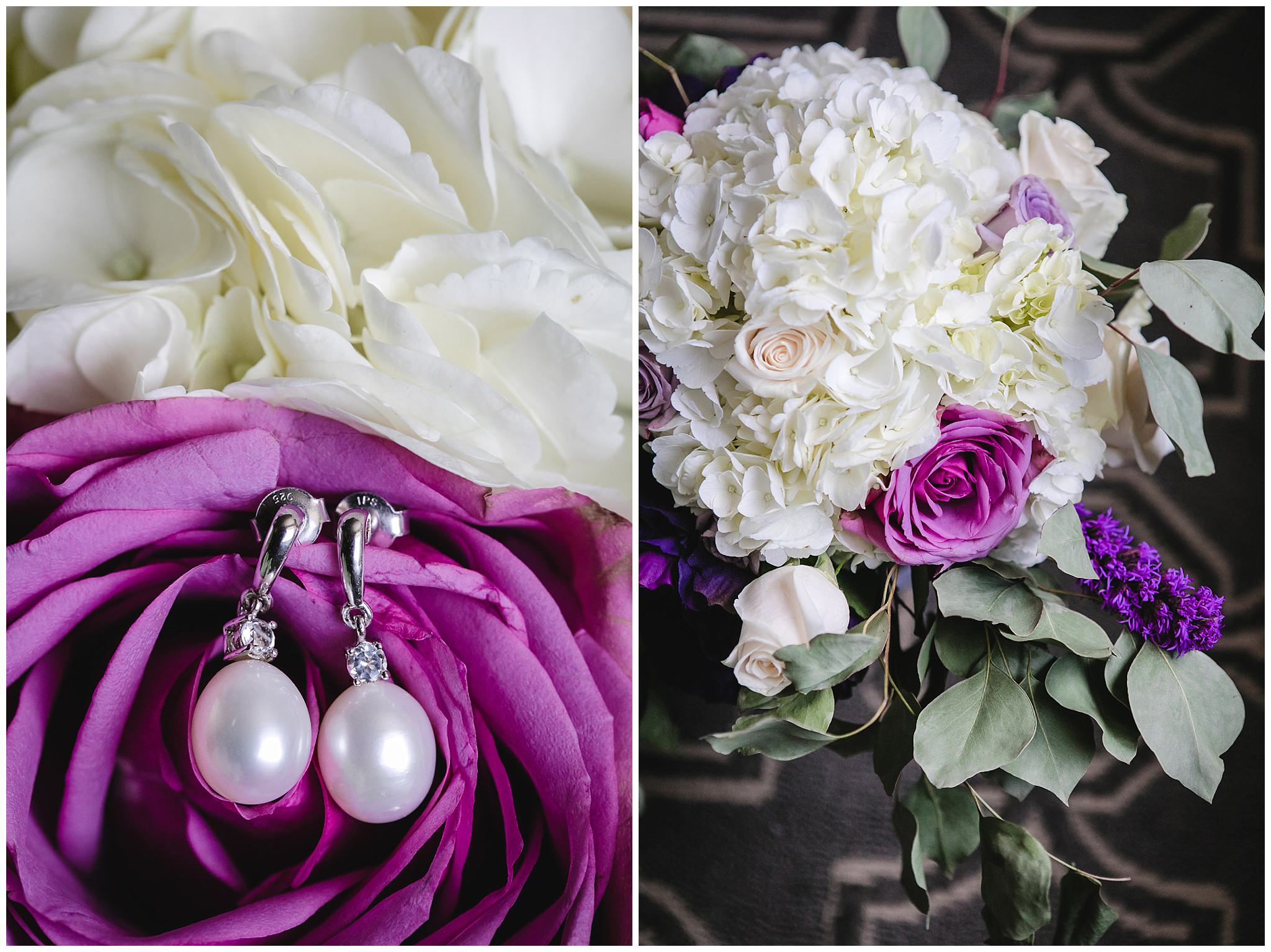 Bride's pear earrings rest in a purple rose in her bouquet