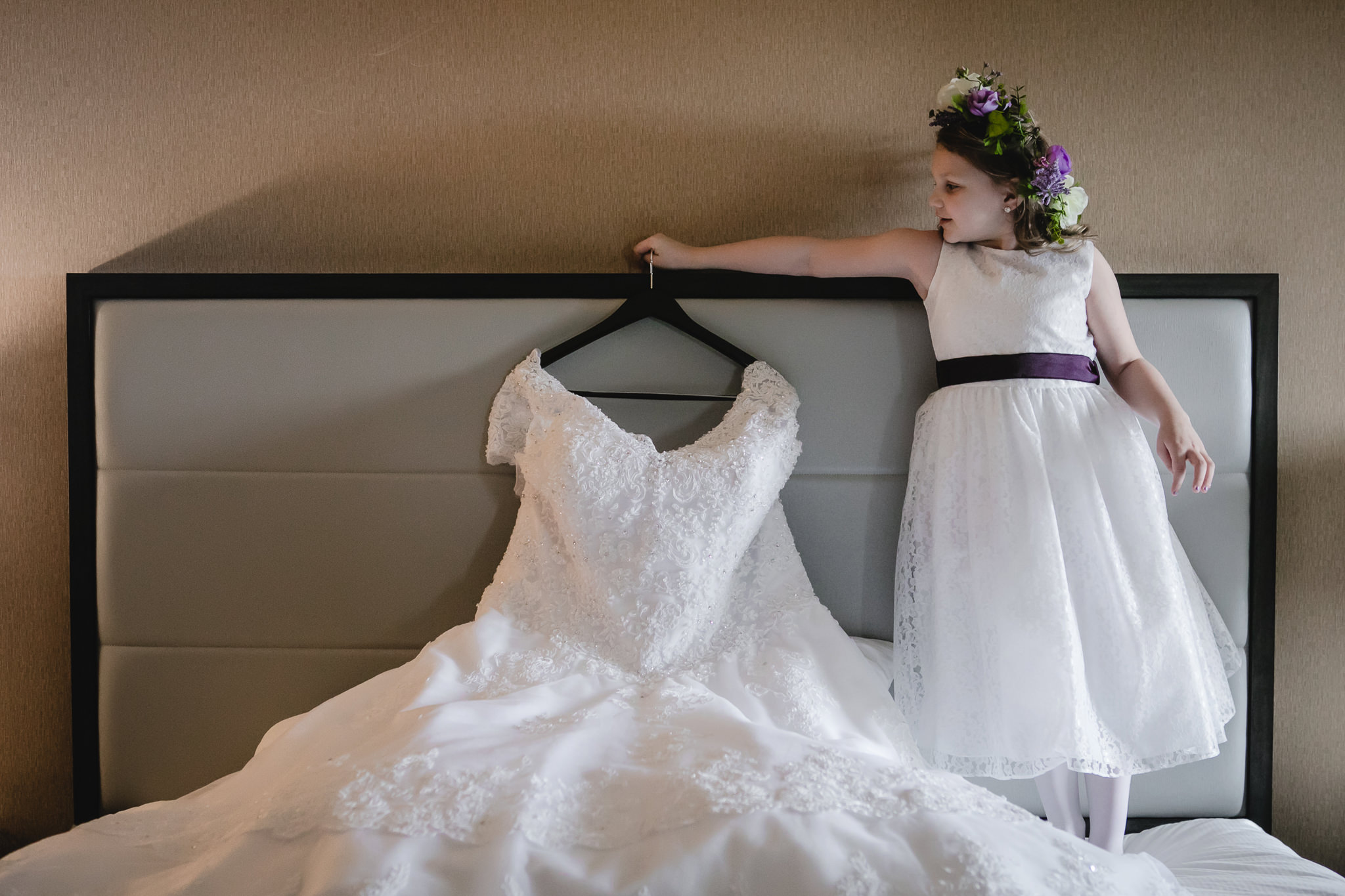 Flower girl holds up bride's dress before her Robinson Township wedding