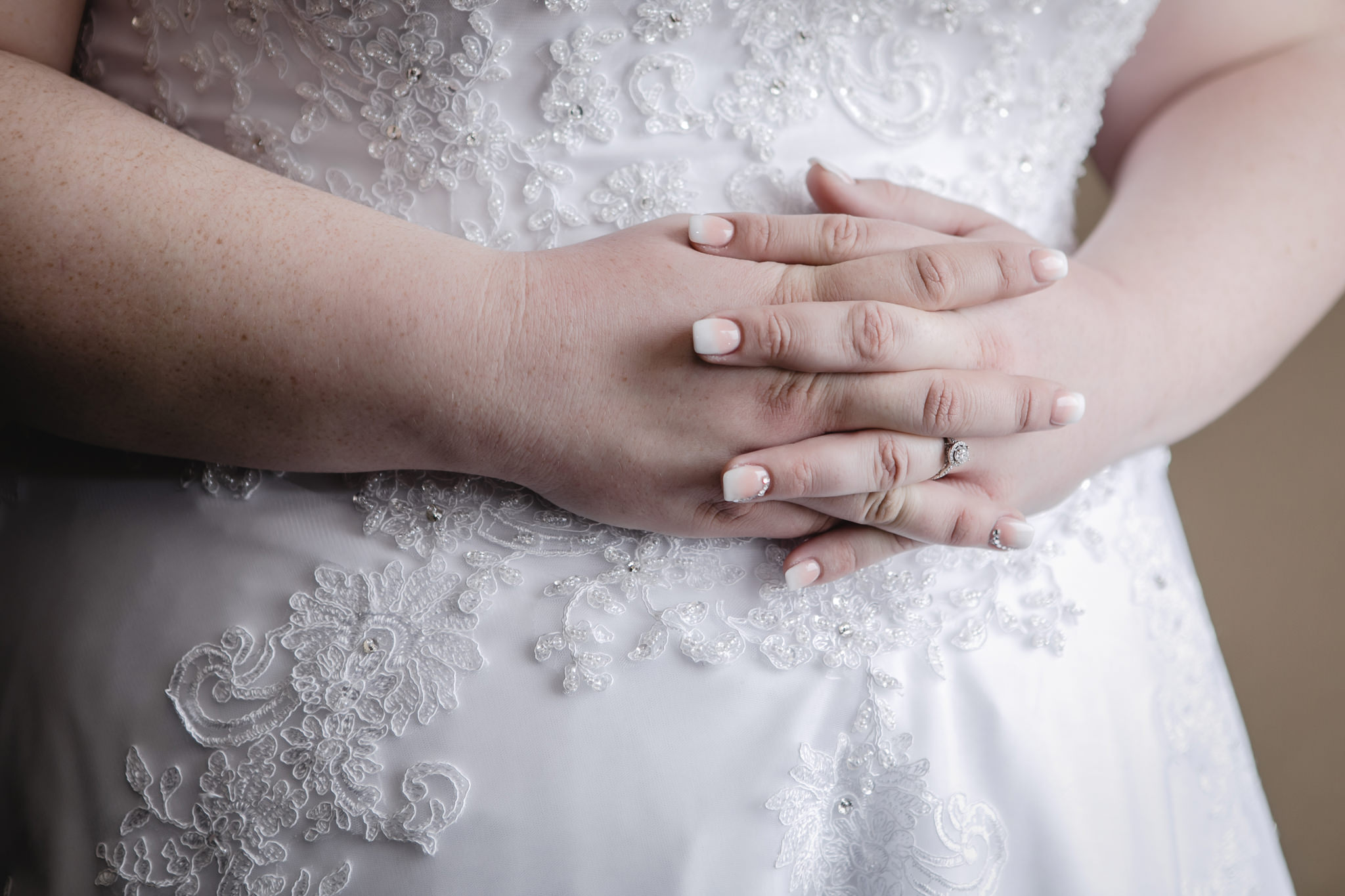 Bride's hands as she gets into her wedding dress in Moon Township, PA