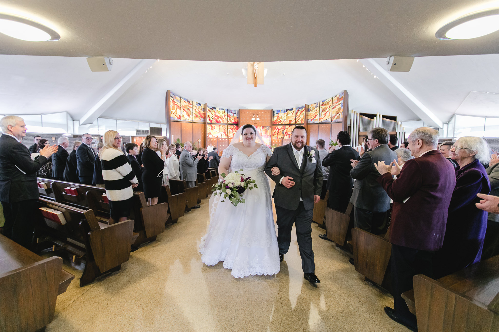 Newlyweds exiting their ceremony at Holy Trinity in Robinson Township