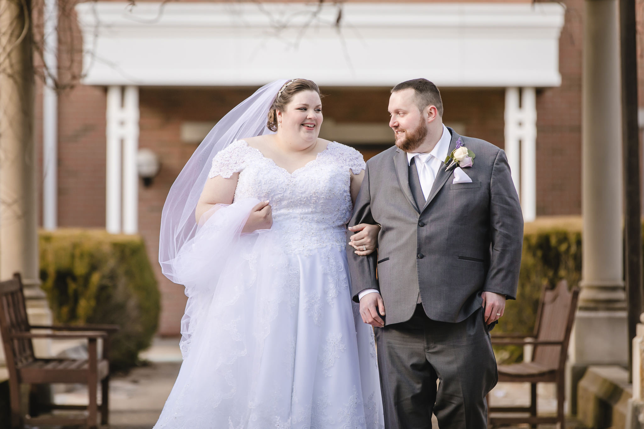 Bride and groom walk through Massey Gardens at Robert Morris University
