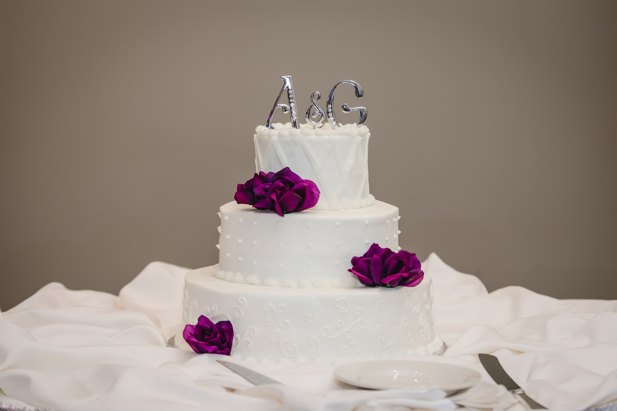 Wedding cake with purple flowers at the Fez